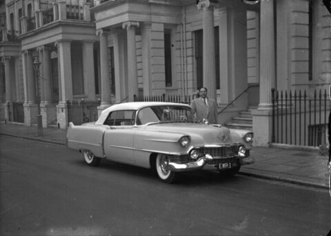 Man And Vintage Cadillac Outside Townhouse
