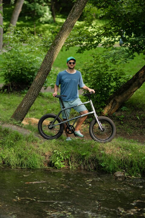 Man With Bicycle by Park Stream