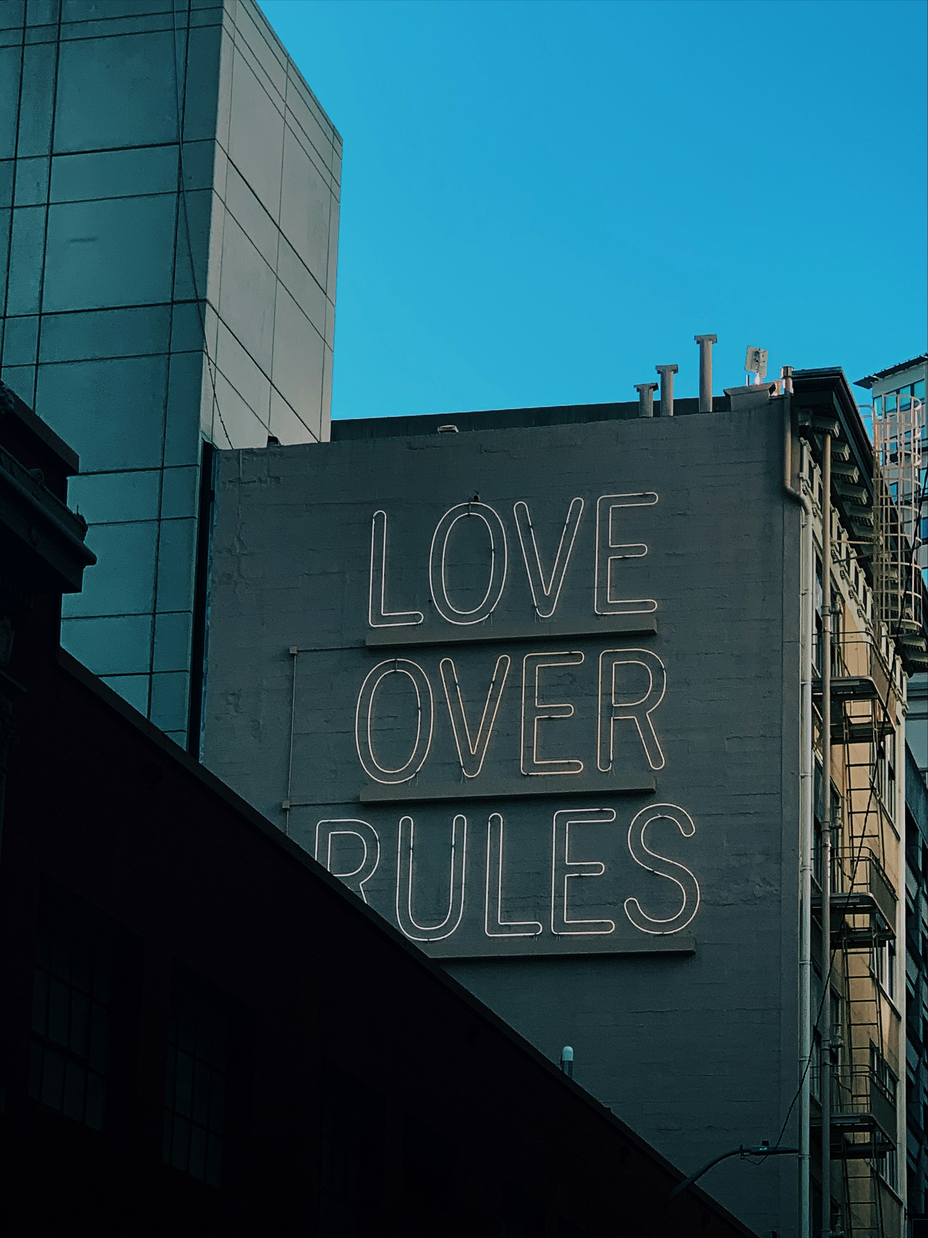 Love Over Rules Sign on City Building