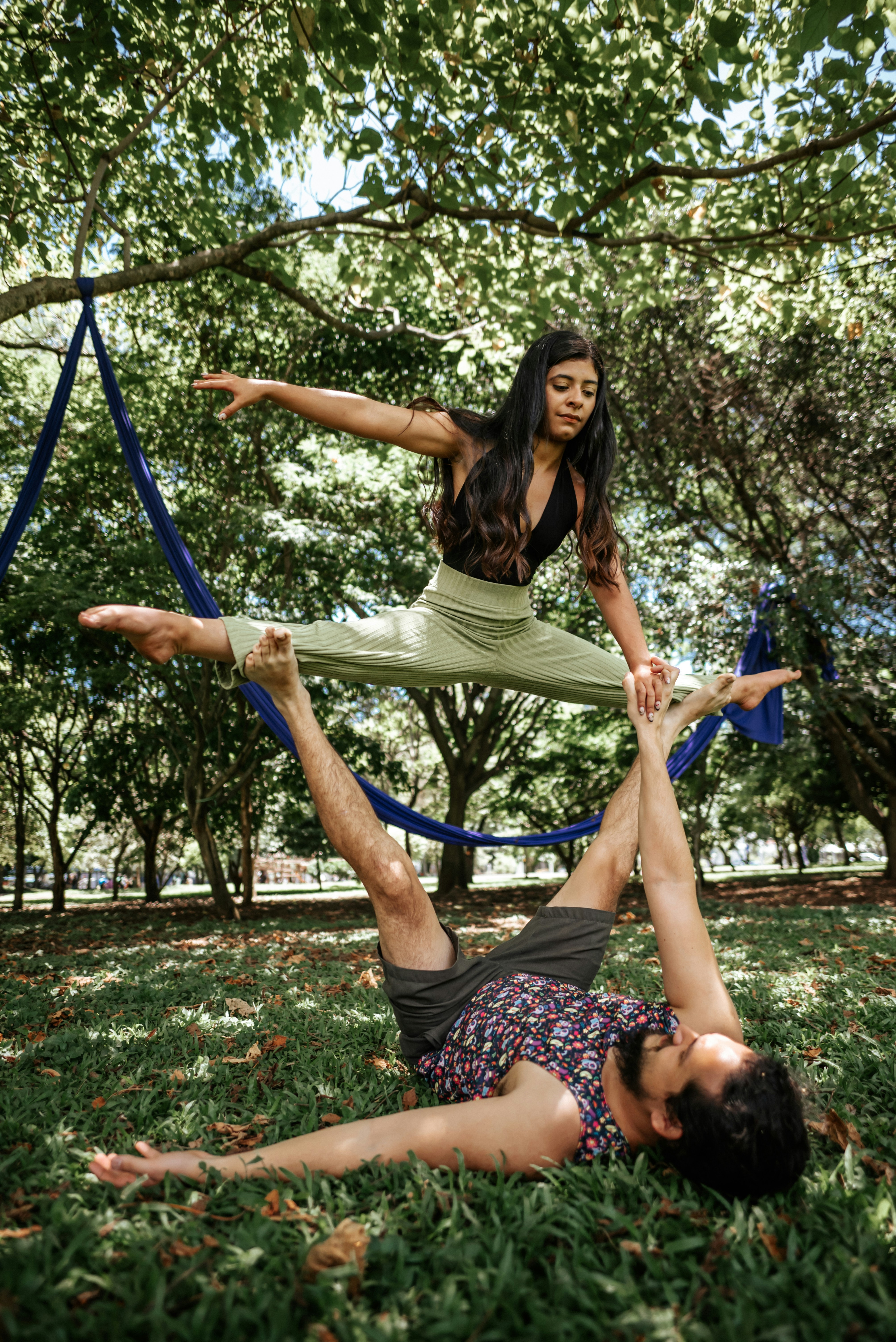 Two People Practicing Acro Yoga in Park