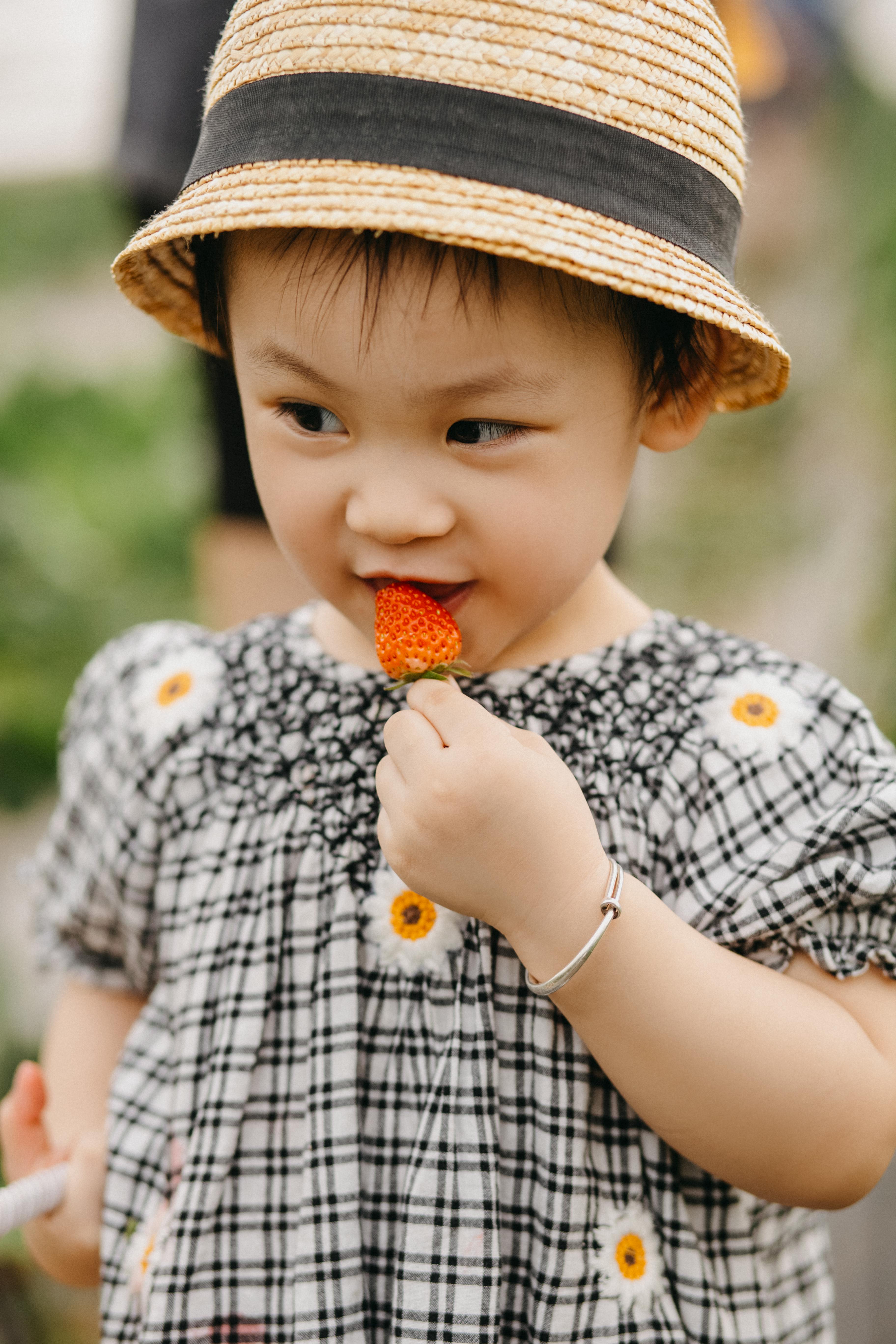 Toddler Girl Eating Fresh Strawberry