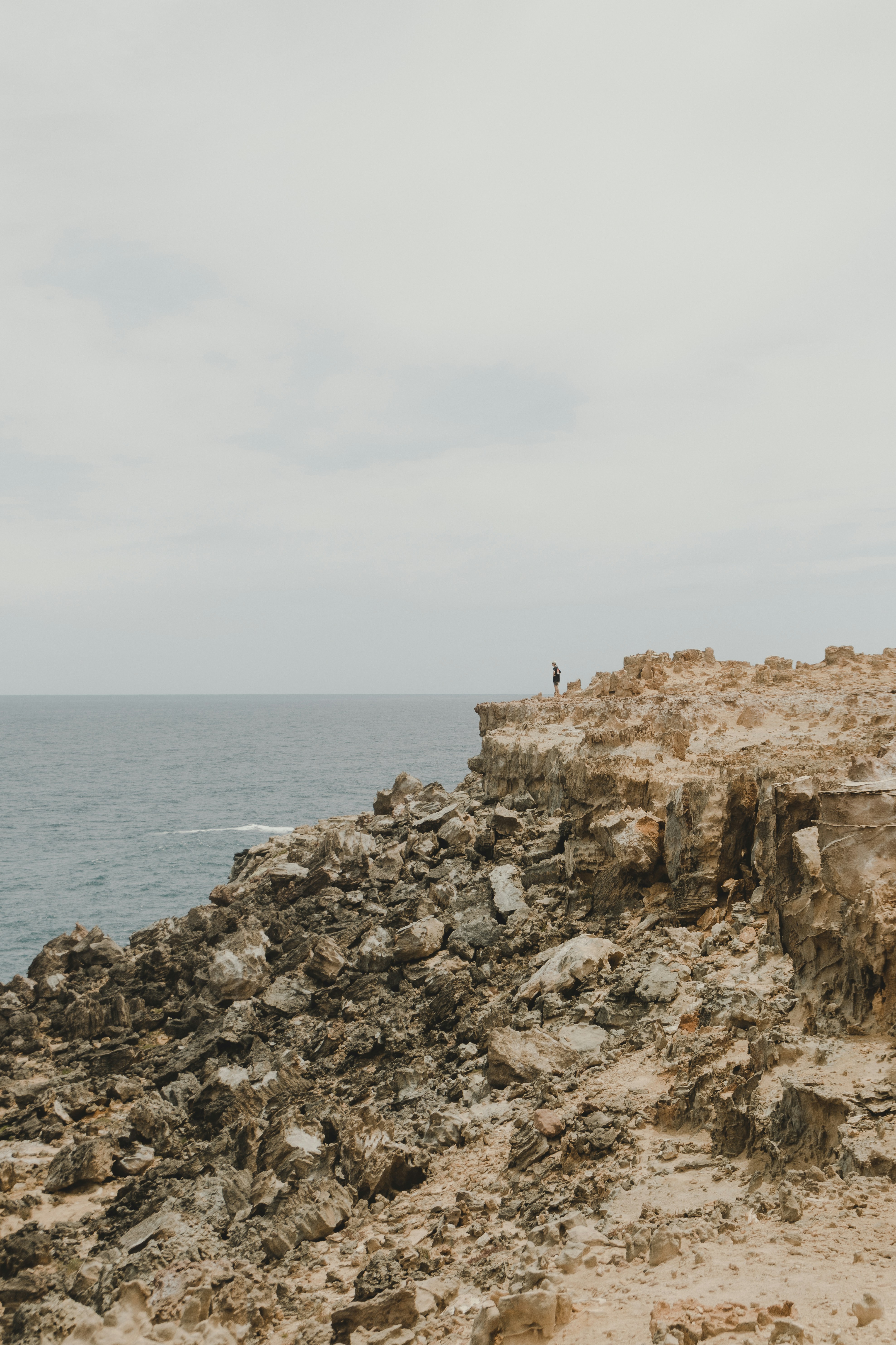 Lone Hiker on Coastal Cliff