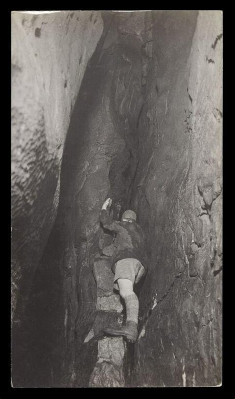 Vintage Rock Climber in Narrow Crevice