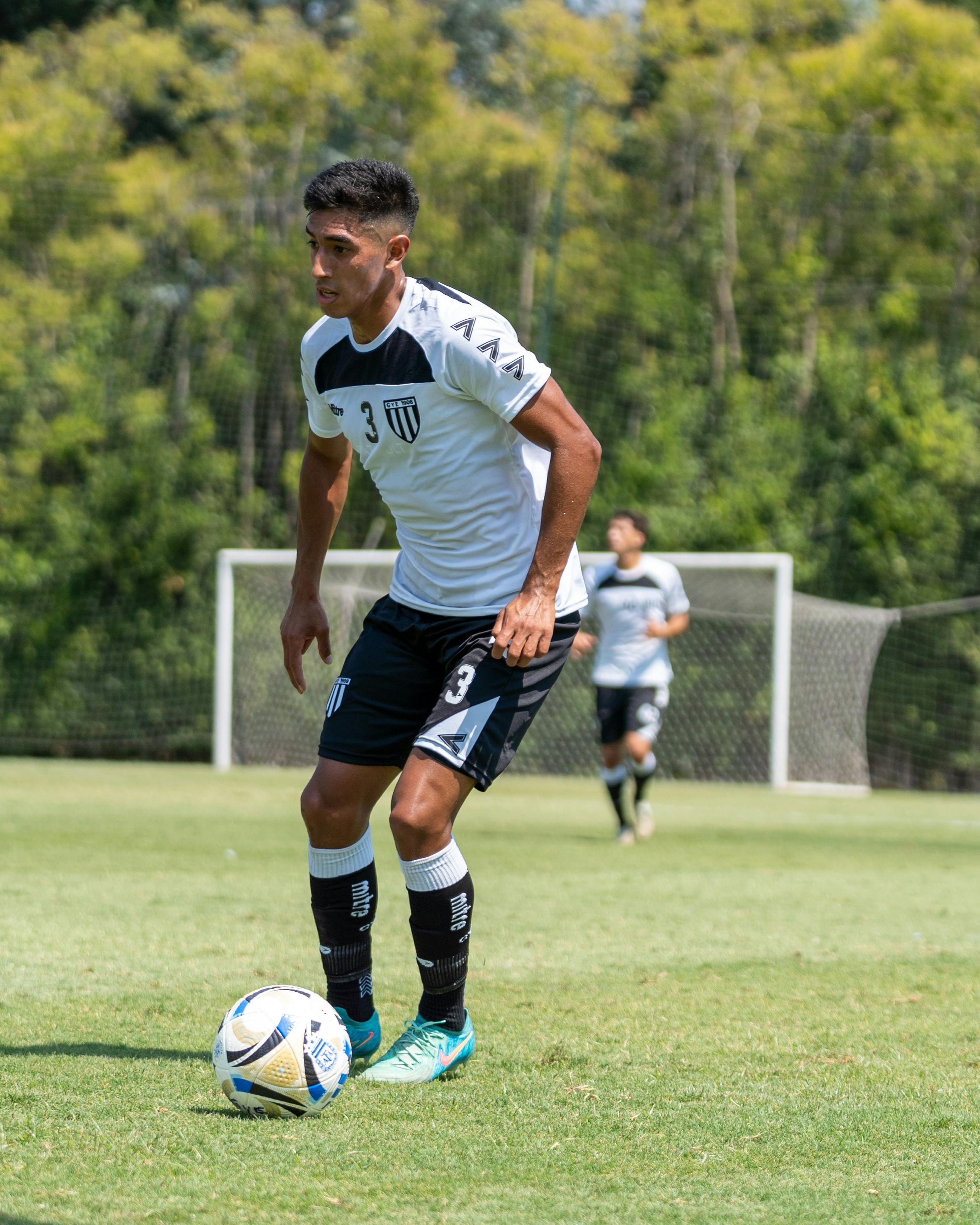 Soccer Player Training on Grass Field