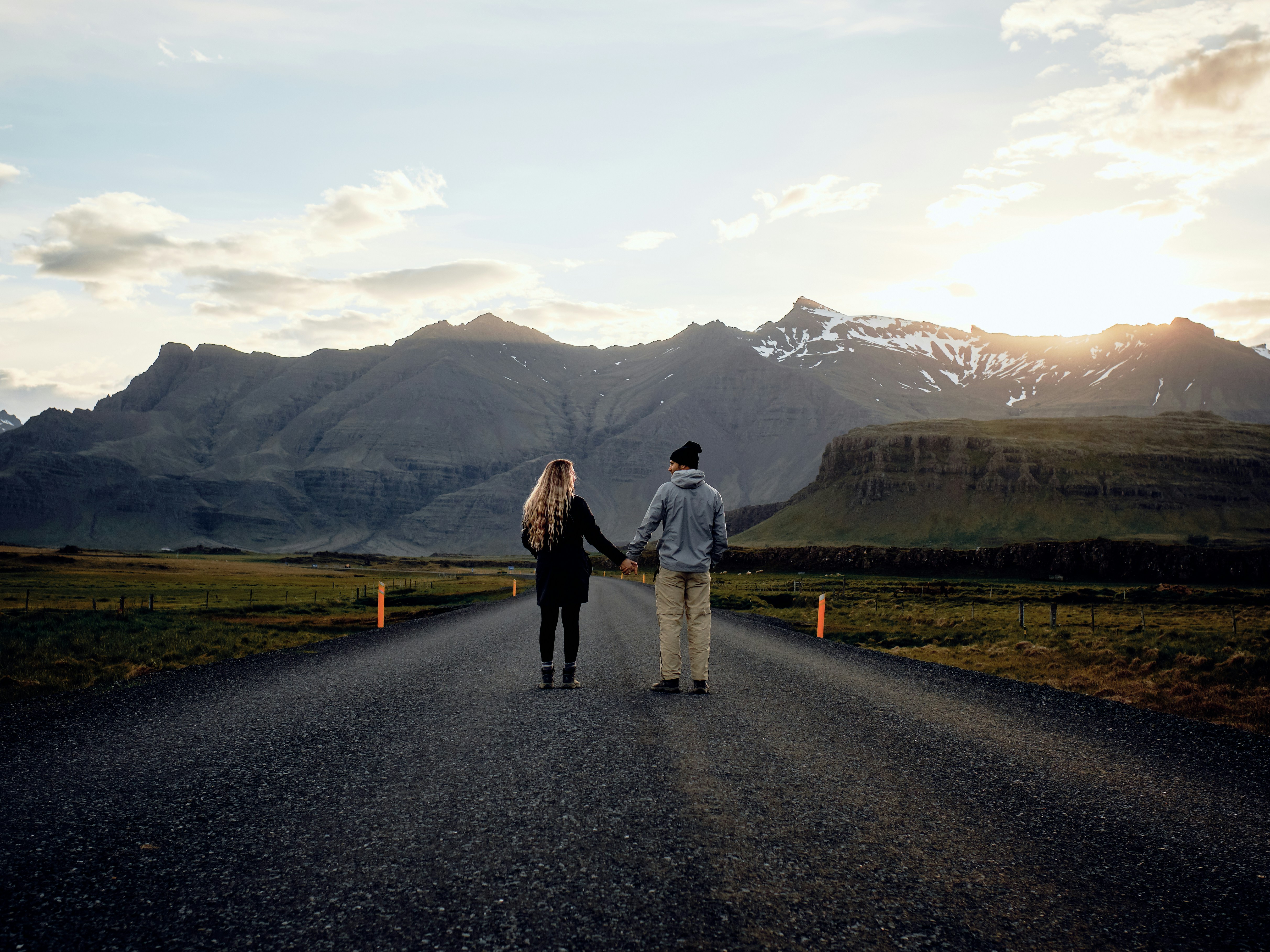 Couple Holding Hands on Mountain Road
