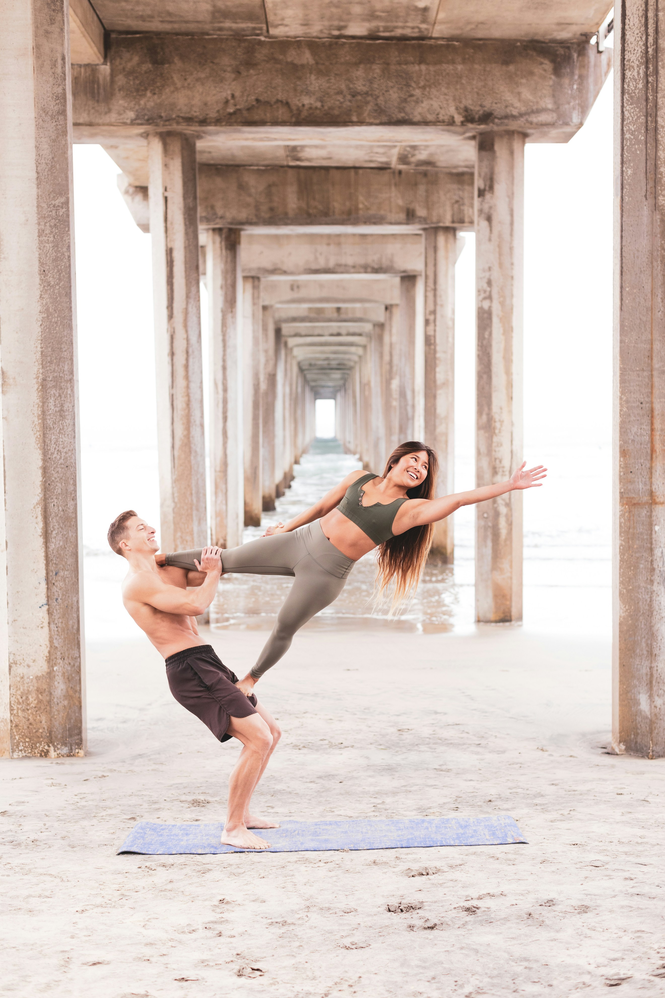 Acro Yoga Practice Under Beach Pier