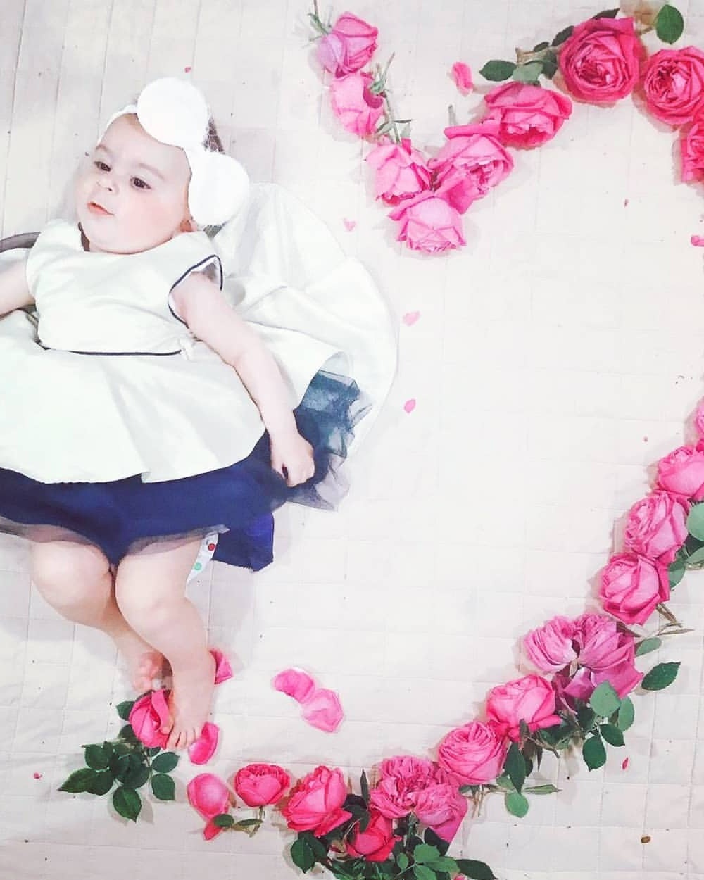 Baby Beside Heart-shaped Pink Roses