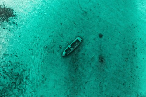 Aerial View of Sunken Boat Under Clear Water
