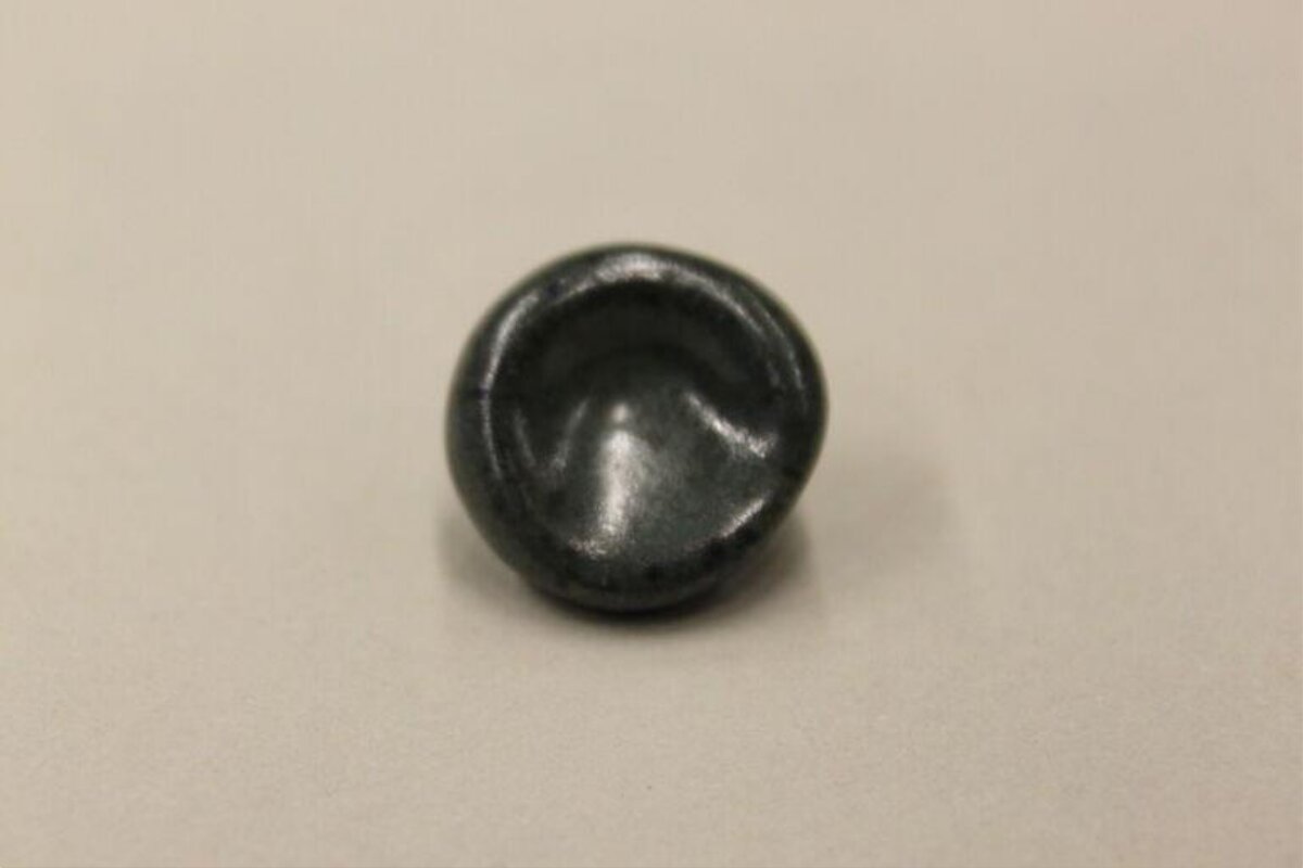 Small Dark Concave Round Object