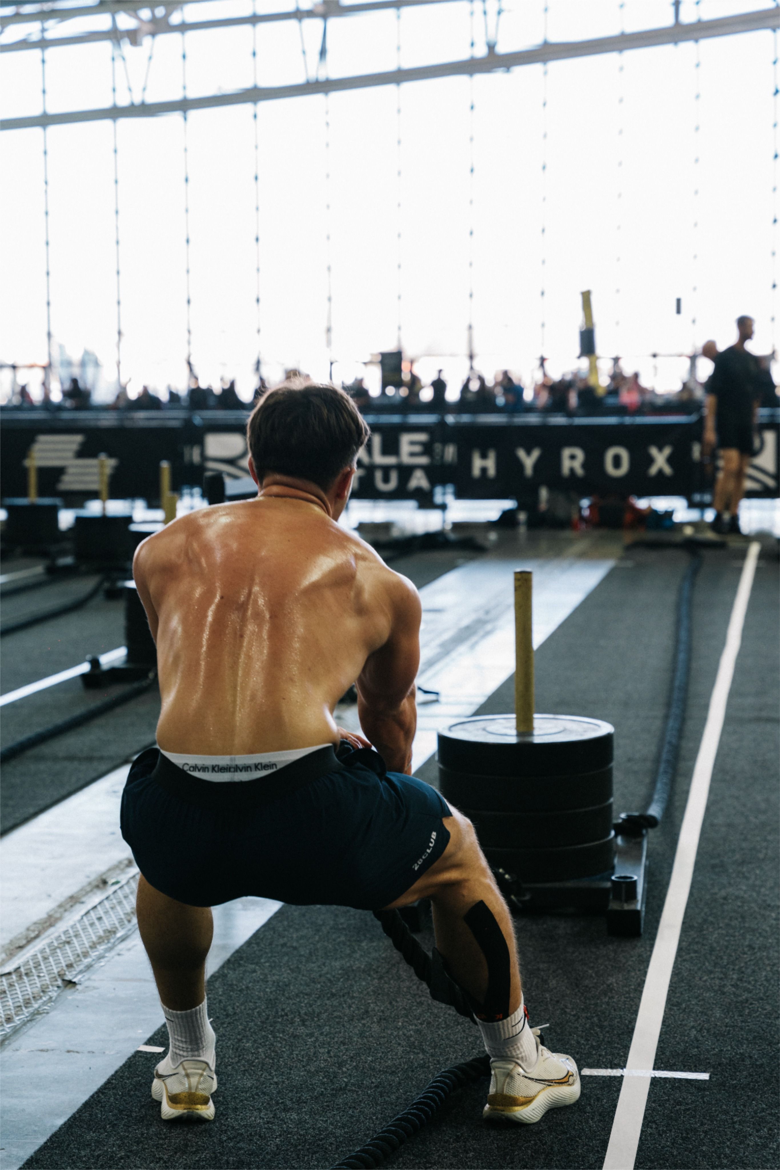 Athlete Pulling Weighted Sled at Hyrox Event