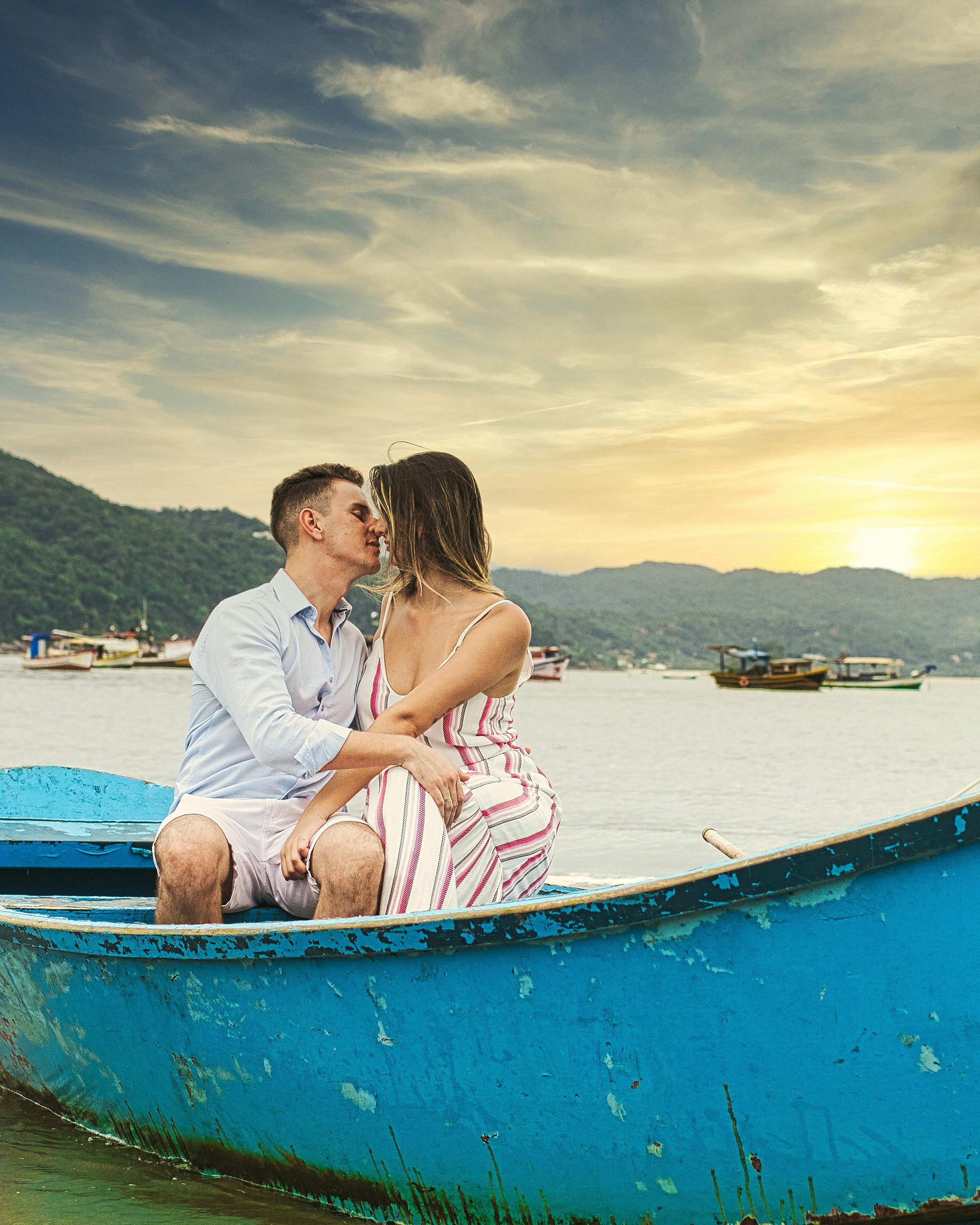 Couple Kissing In Boat At Sunset