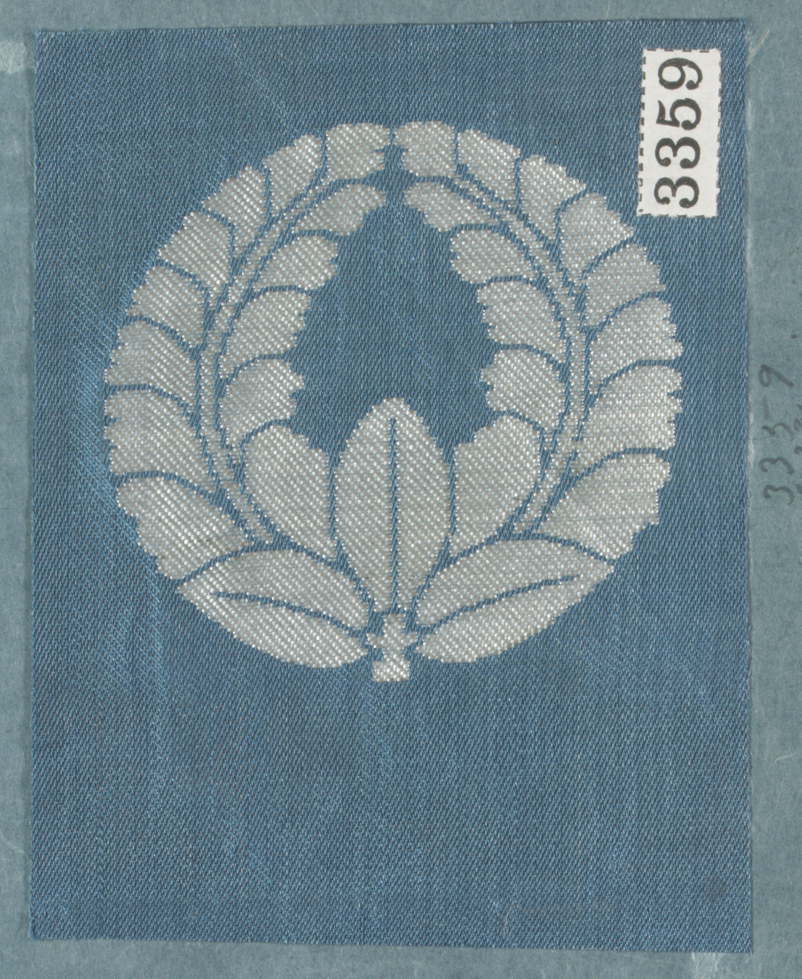 Woven Silver Laurel Wreath on Blue Fabric — Logos