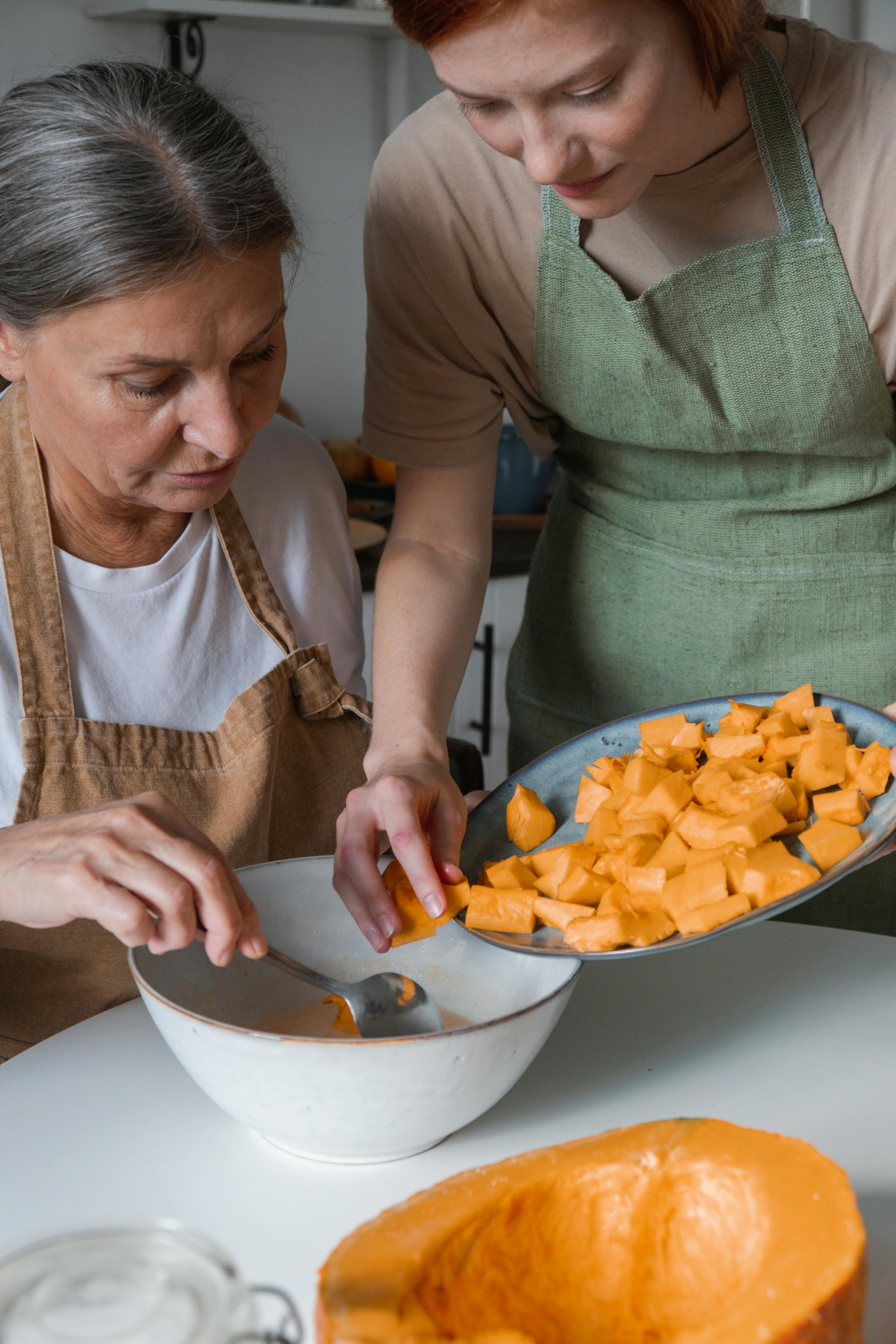 Two Women Preparing Pumpkin for Cooking