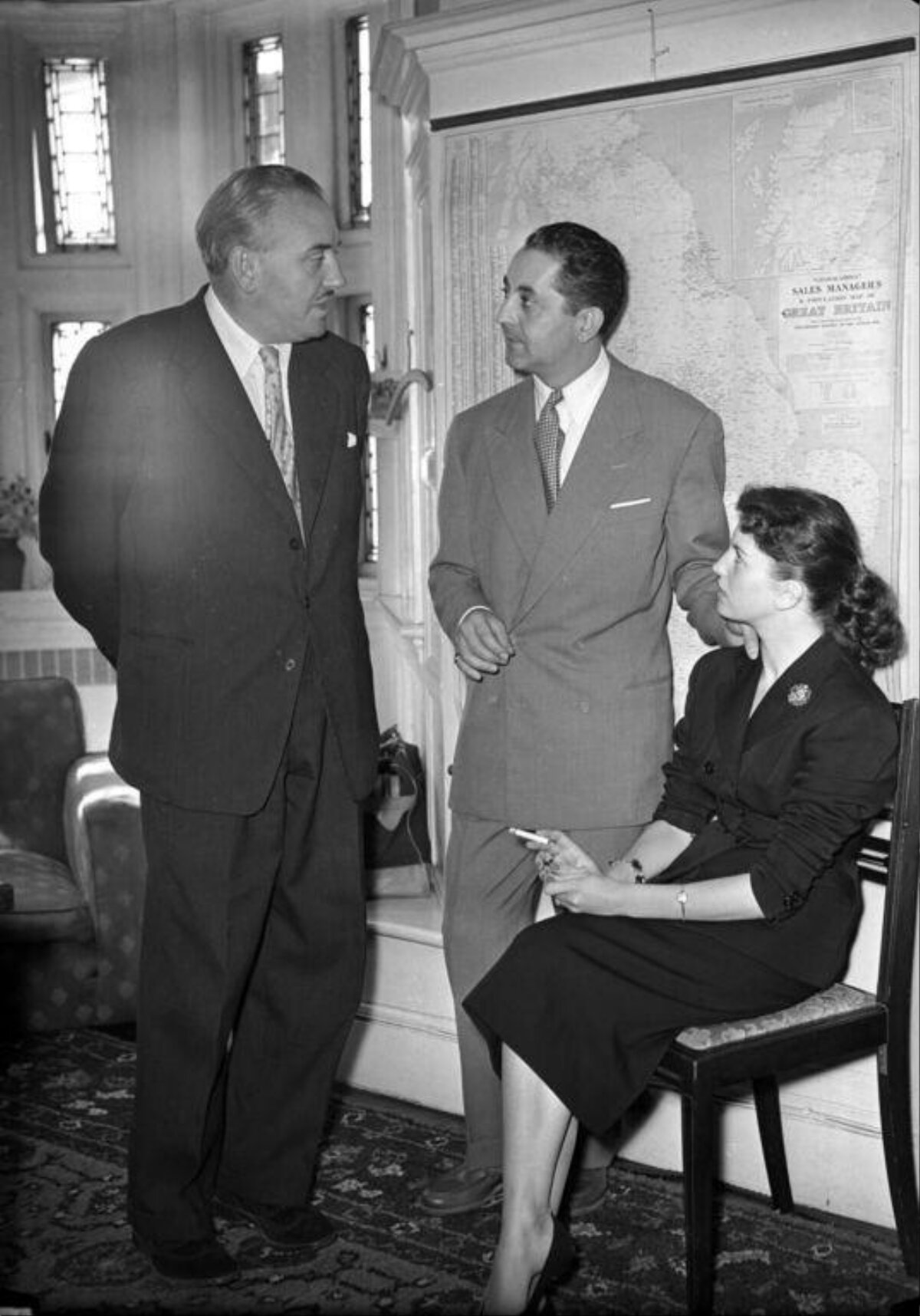 Three People Talking in Mid-century Office