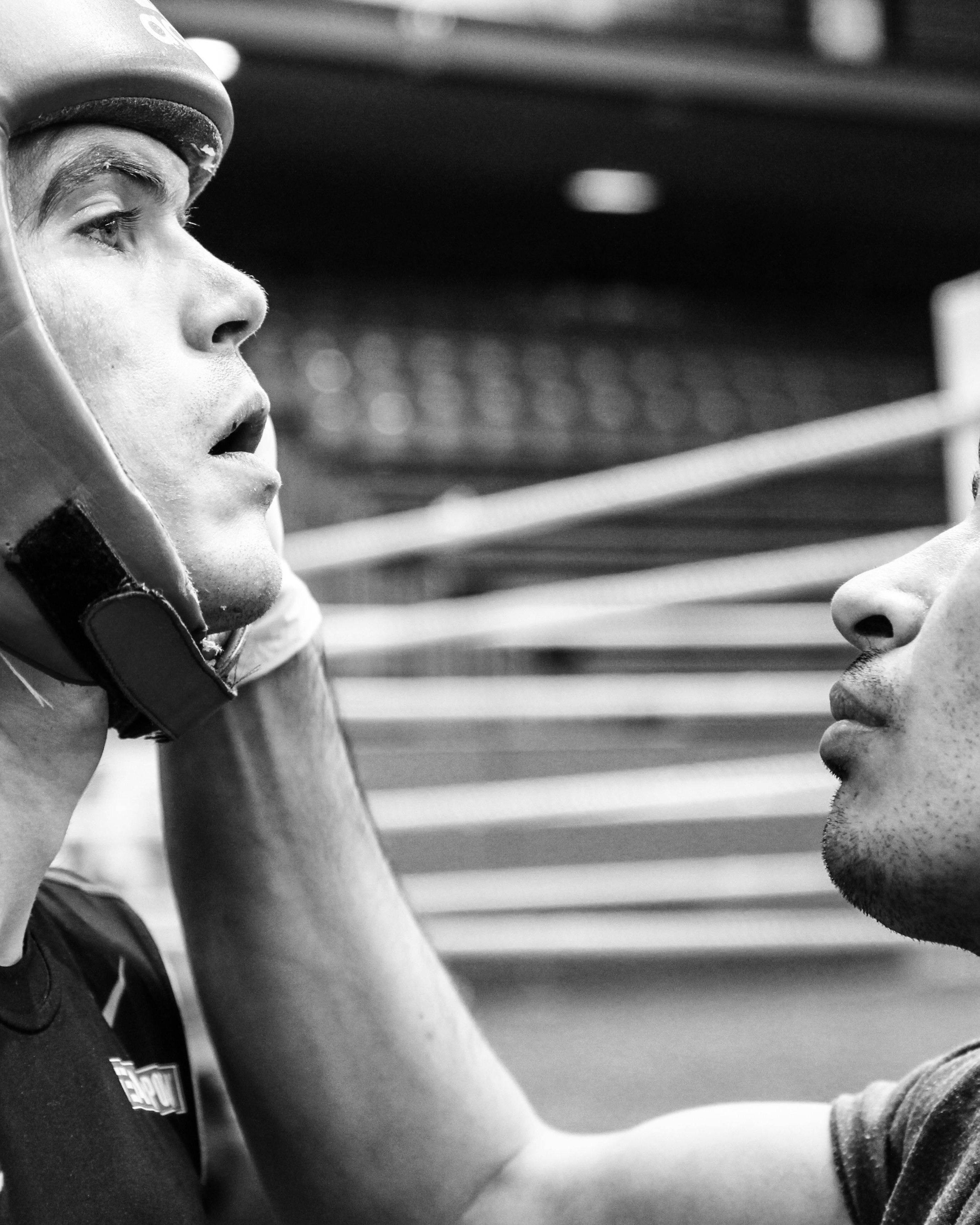 Coach Adjusting Boxer's Headgear