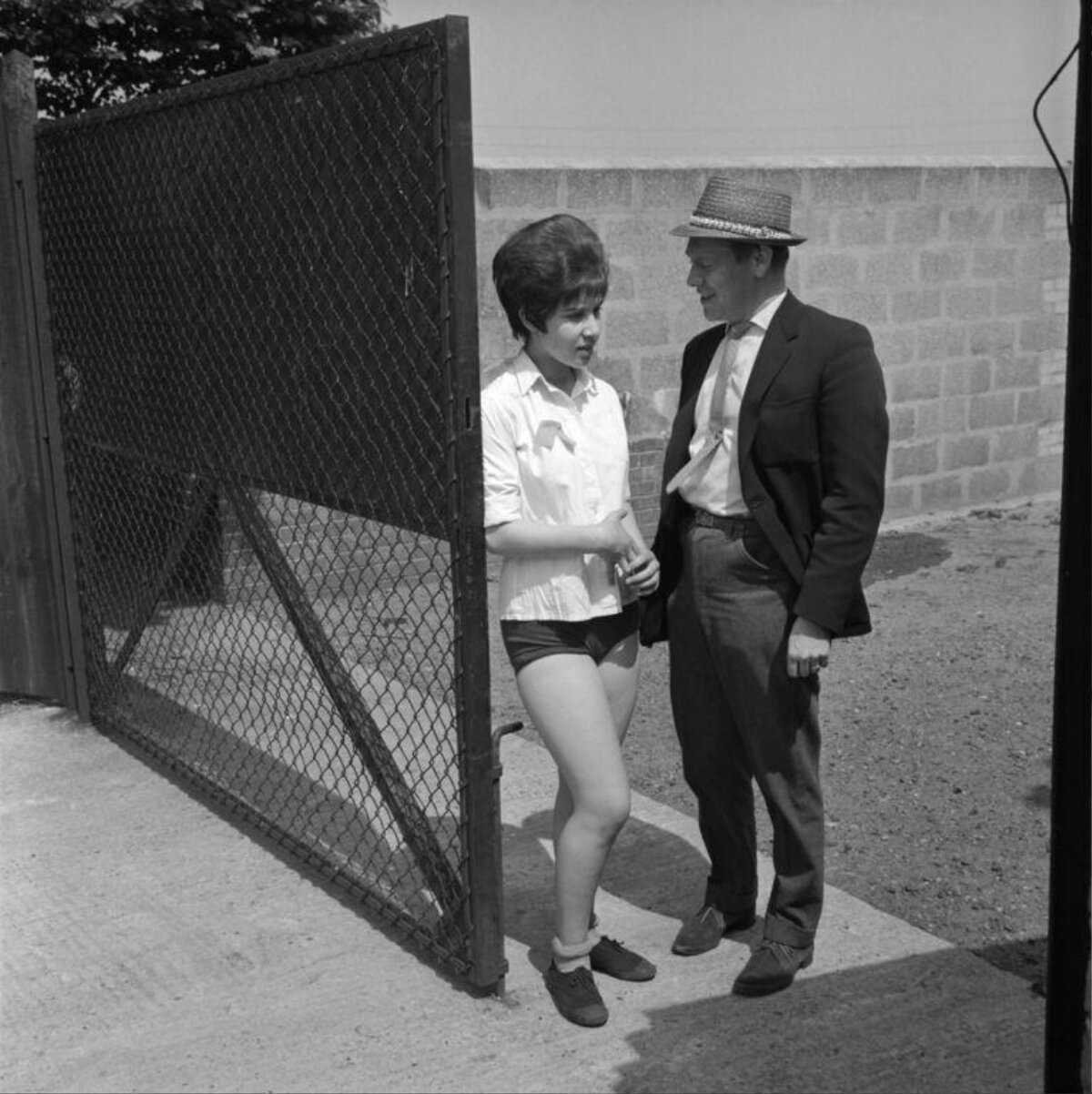 Man and Woman Chat by Open Gate
