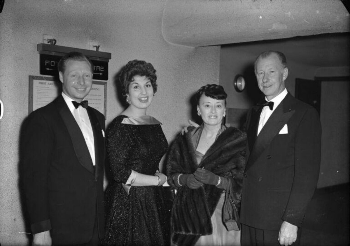 Four formally dressed people posing