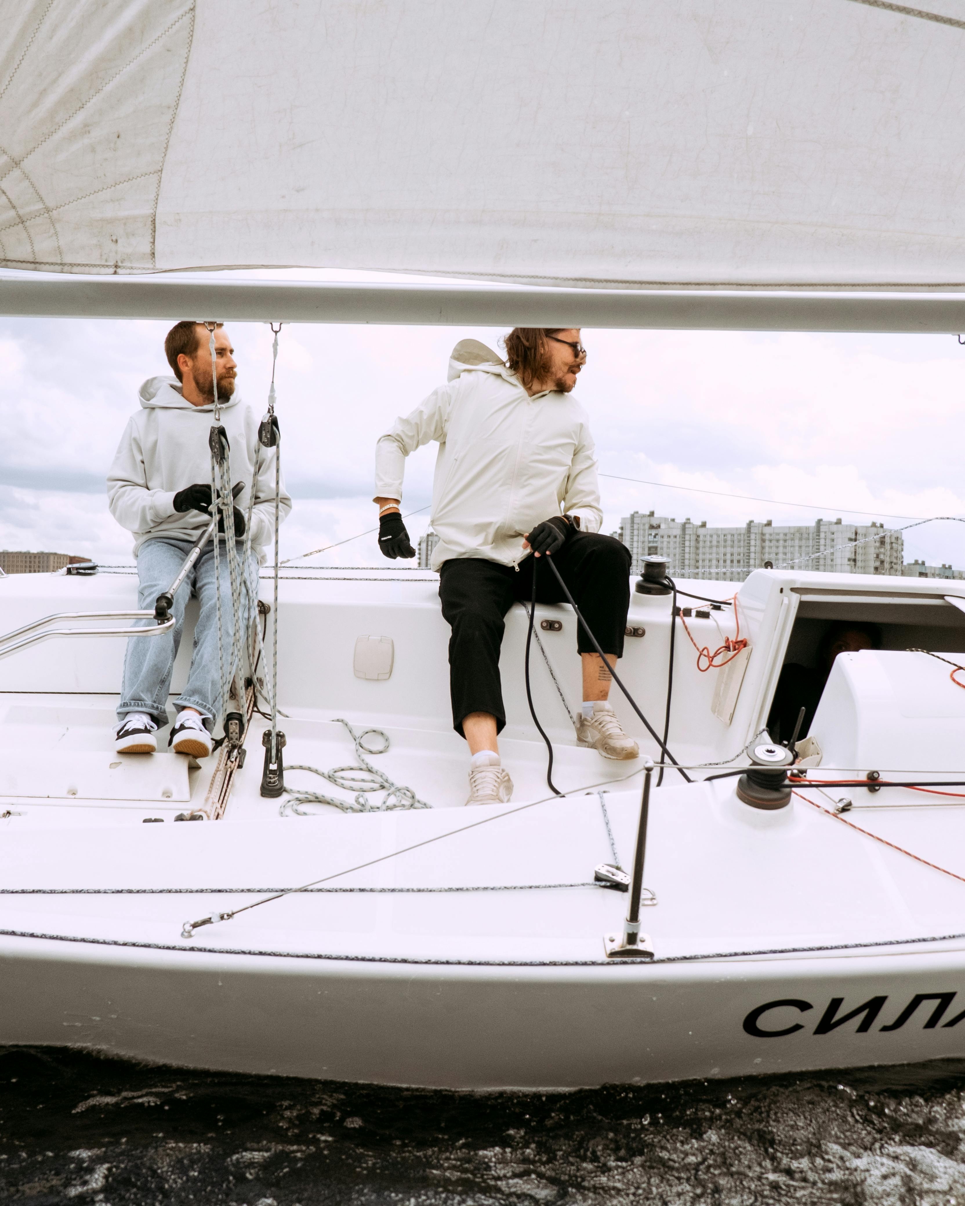 Two Men Sailing On Sailboat