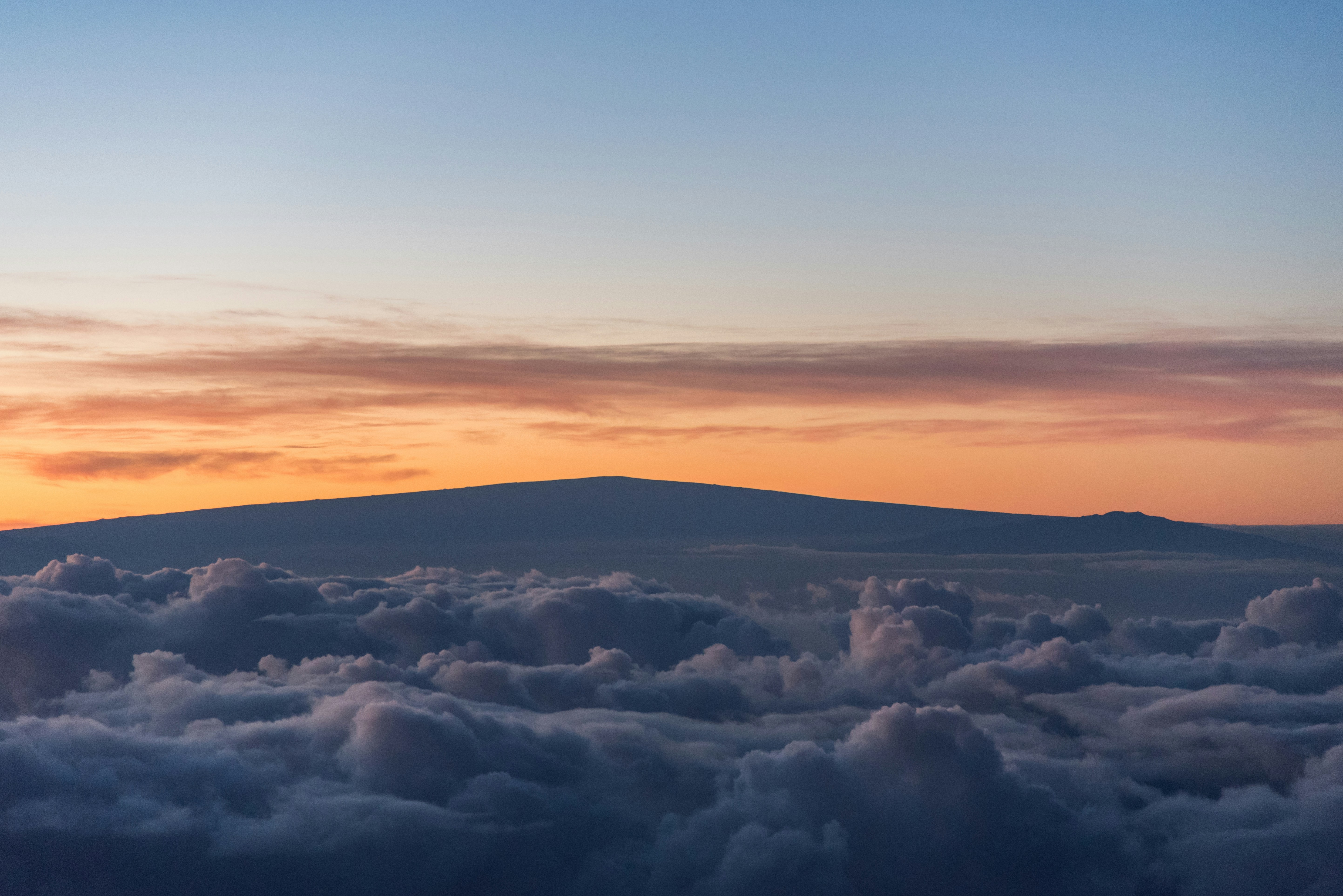 Mountain Peak Above Clouds at Sunset