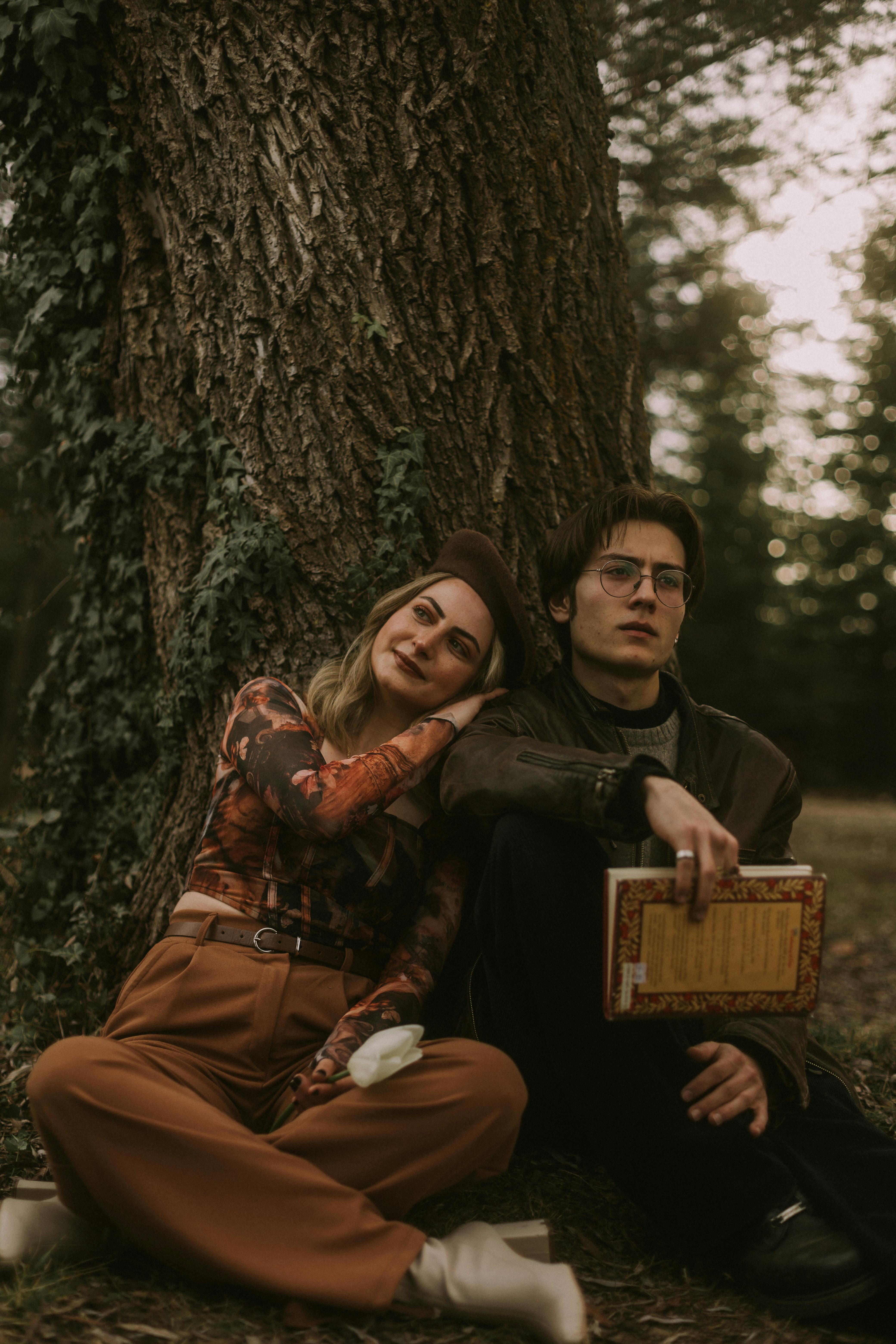 Couple Resting Against a Tree Trunk