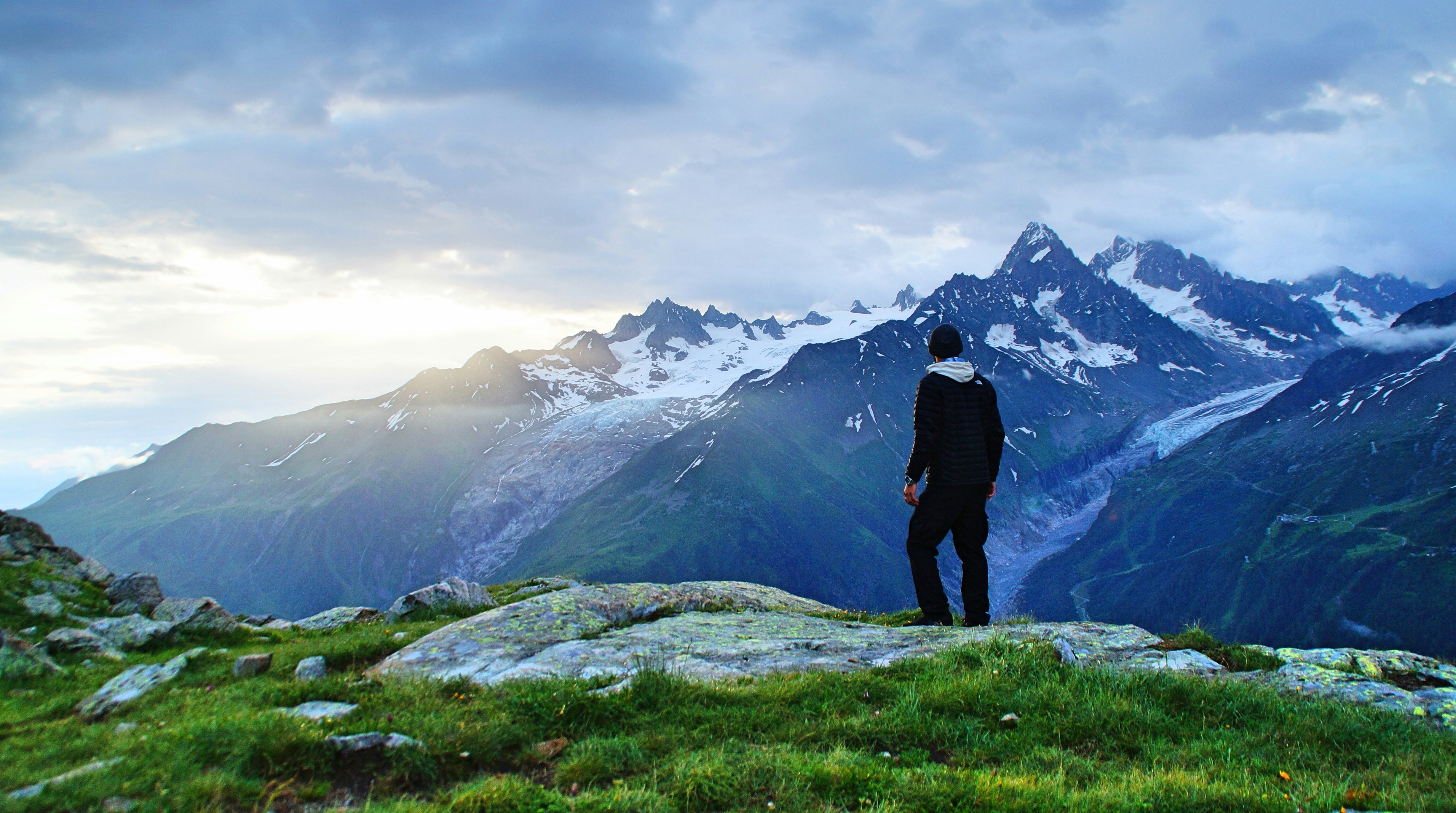 Hiker Overlooking Snowy Mountains