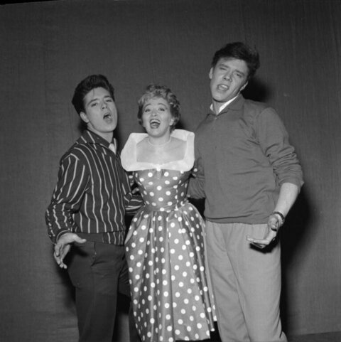 Three Performers Singing Together