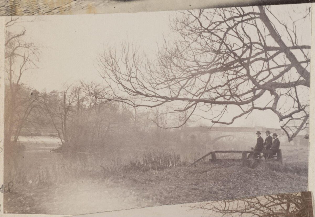 Vintage Riverside Scene with Three Men