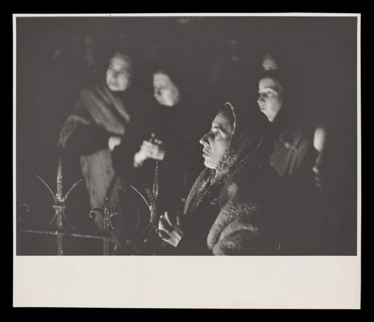 Women Praying in Dim Religious Gathering