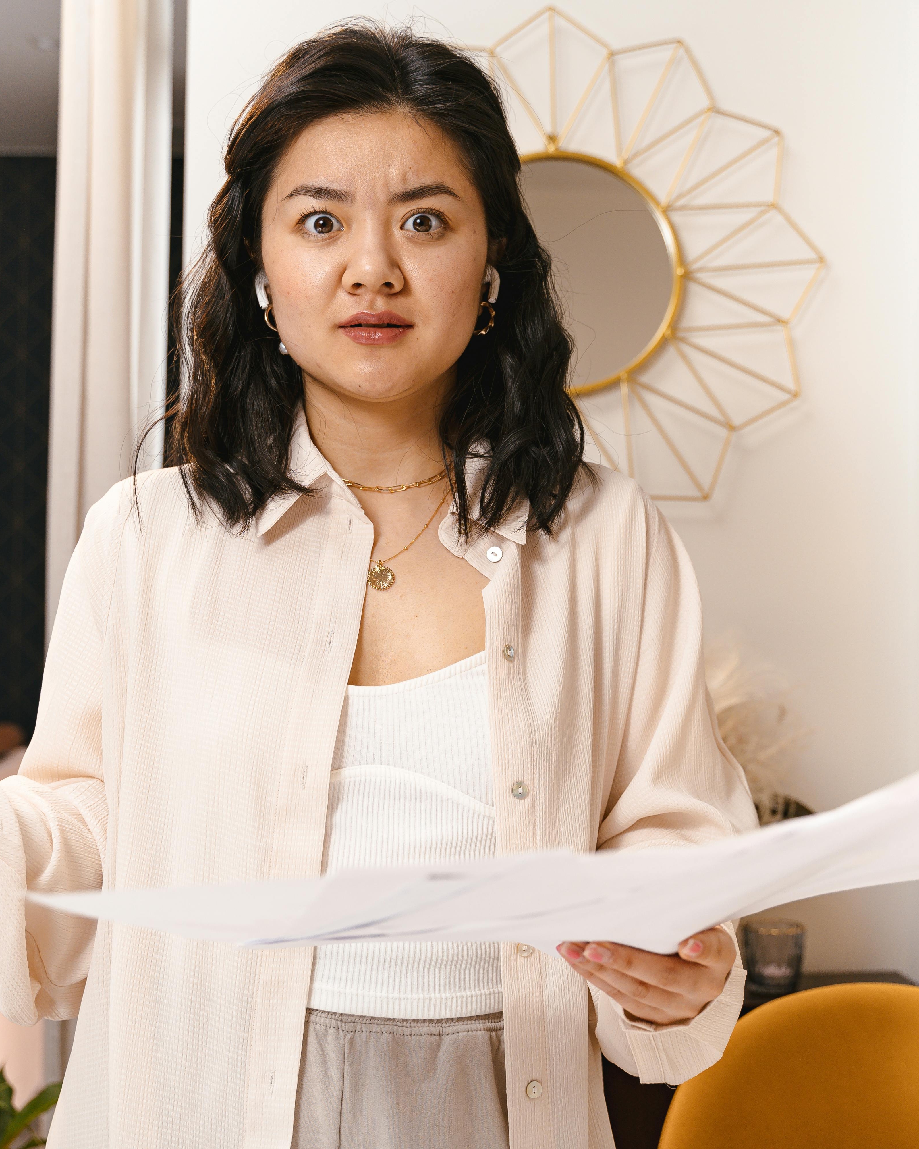 Surprised Woman Holding Documents