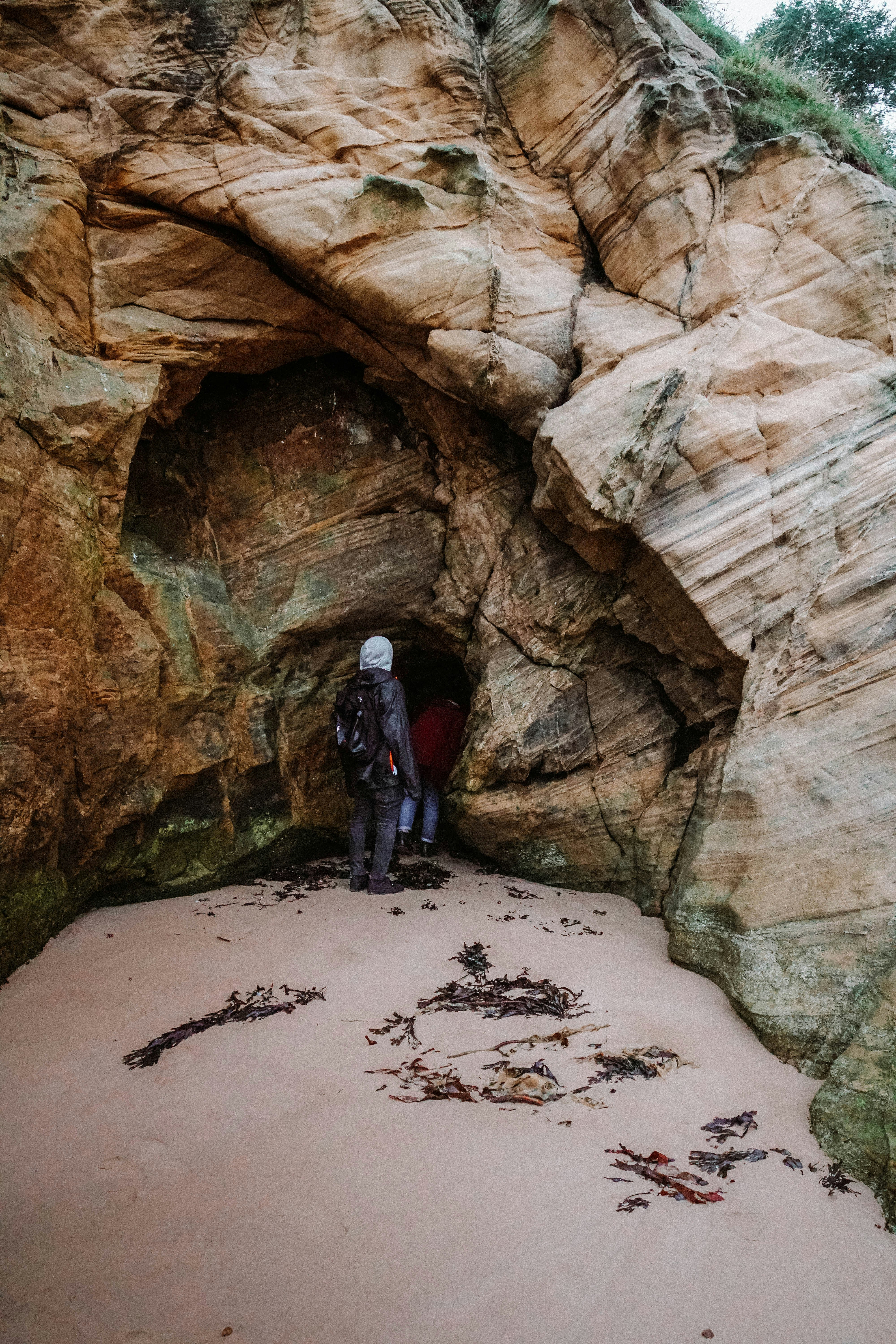Two Explorers Entering Beach Cave