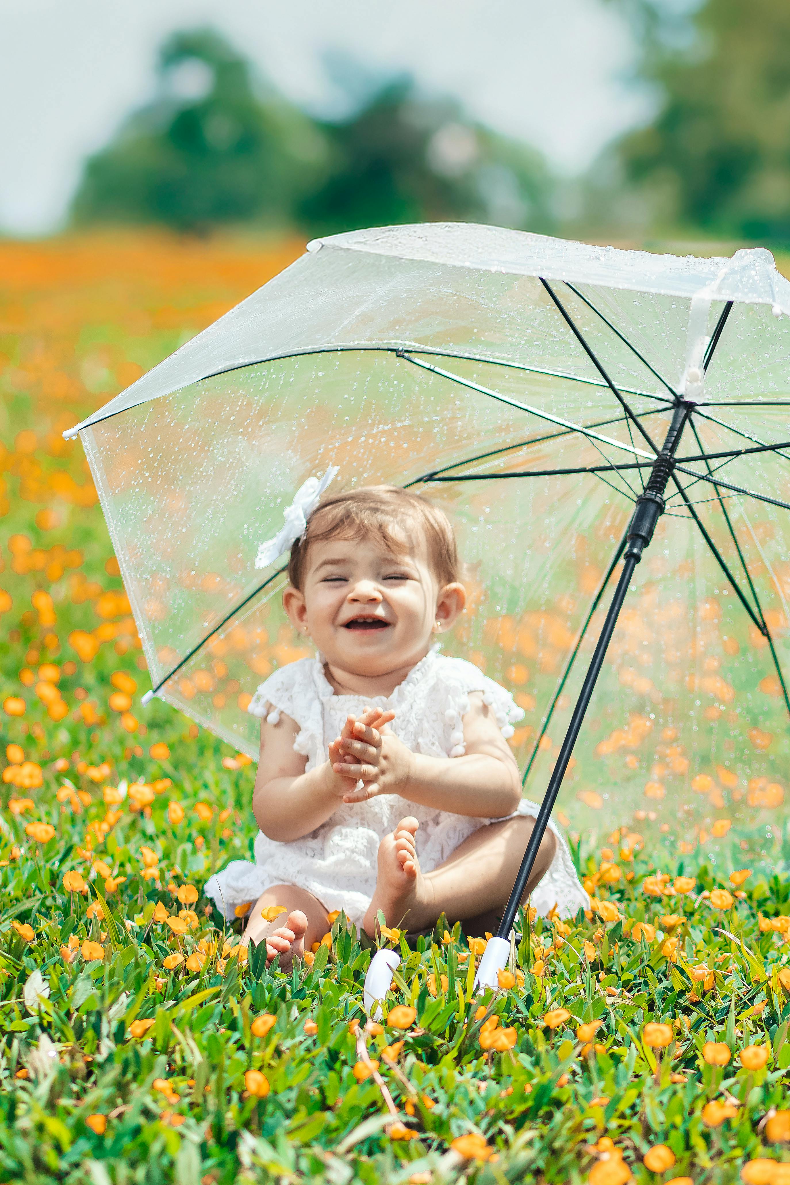 Laughing Baby in Orange Flower Field