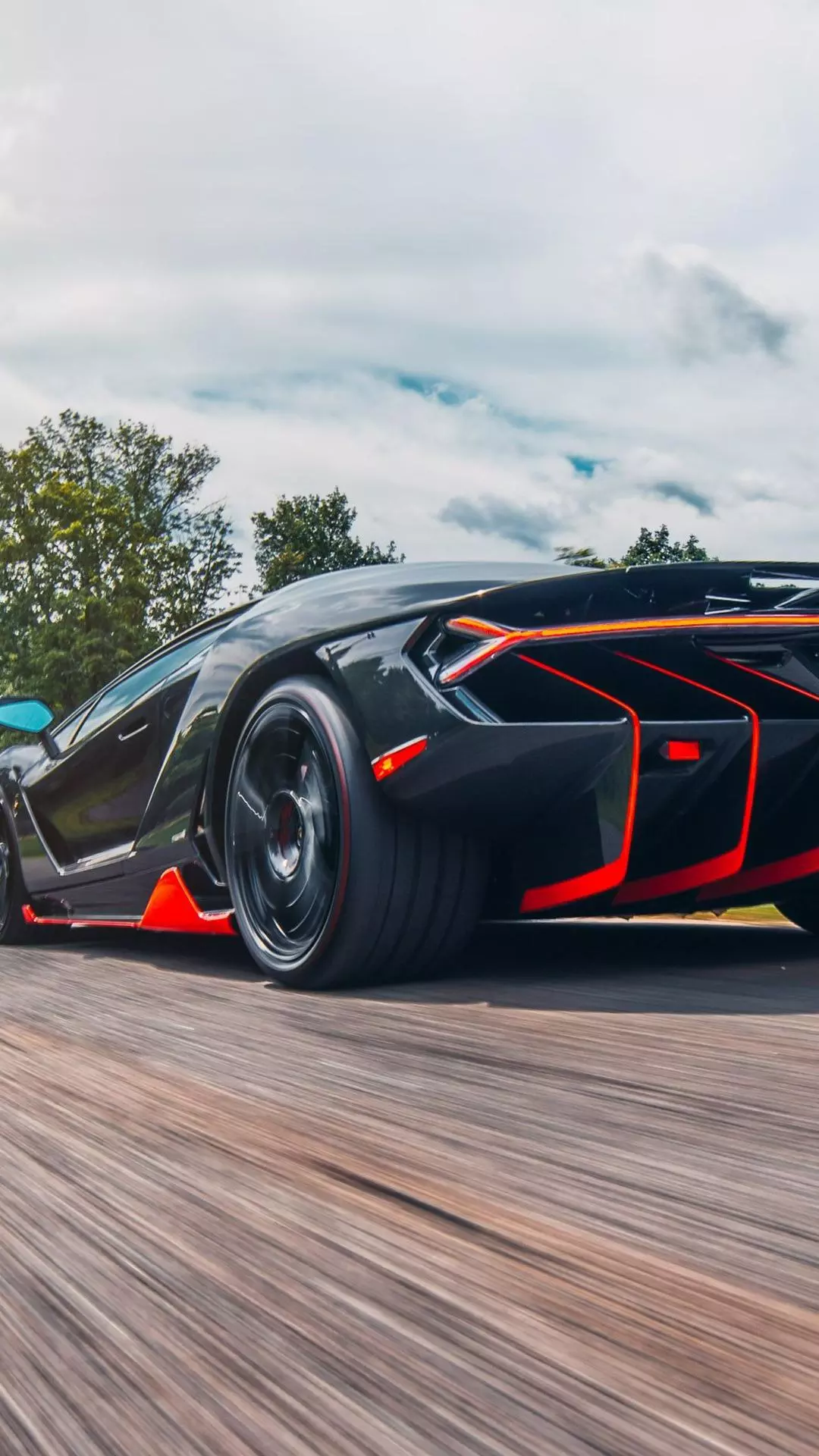Black Supercar Driving on Road