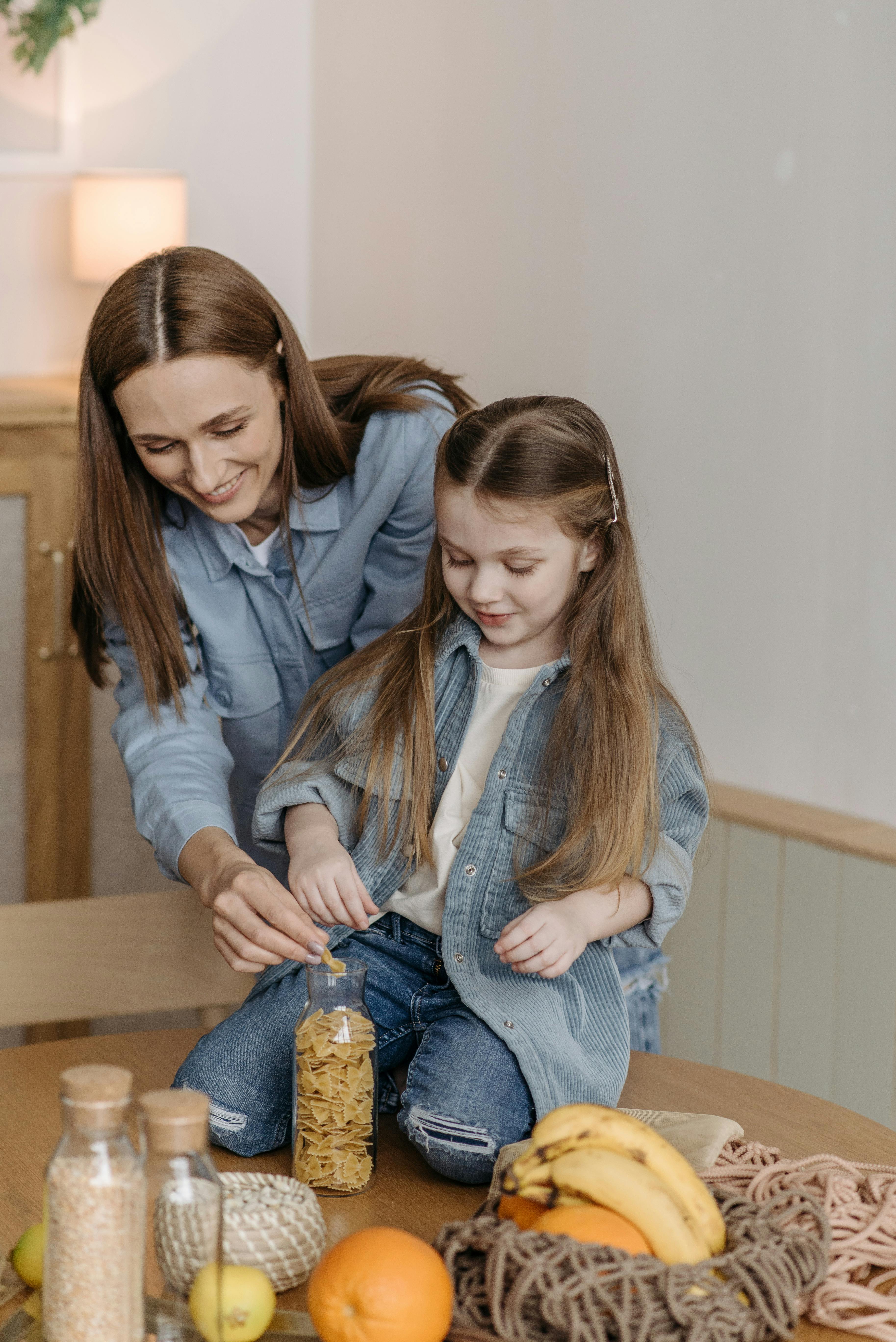 Mother and Daughter Sorting Groceries