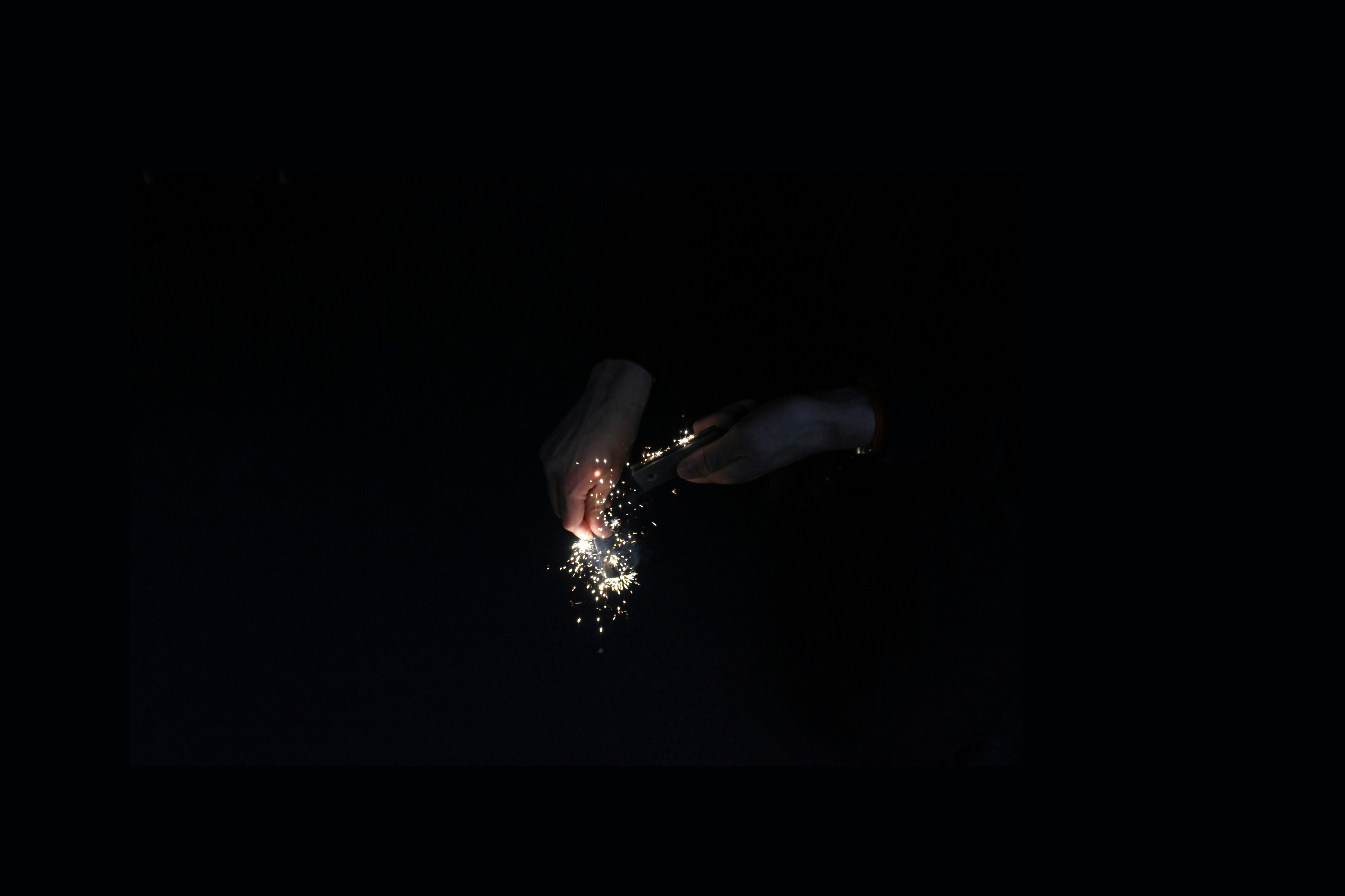 Striking Fire Starter Making Sparks in Darkness