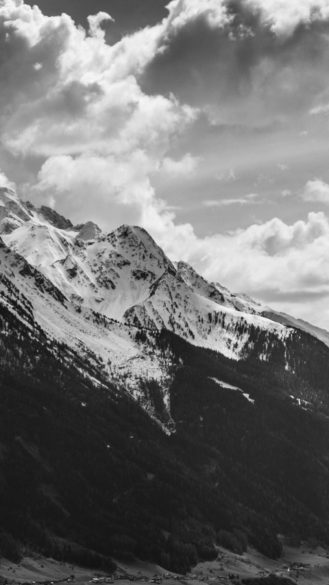 Snowy Mountain Range Under Cloudy Sky