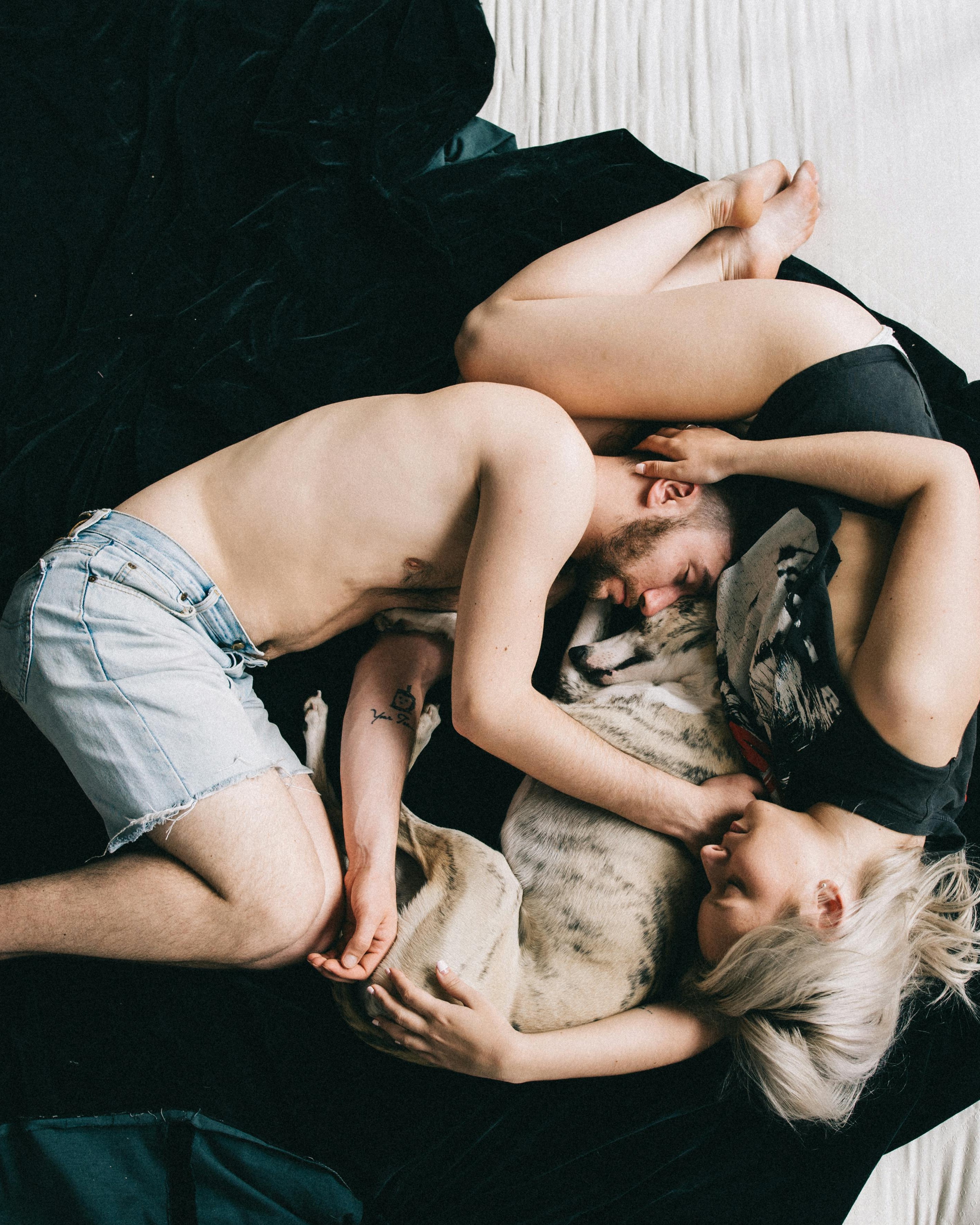 Couple and Dog Cuddling Together
