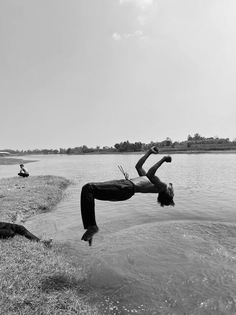Man Backflipping Into River