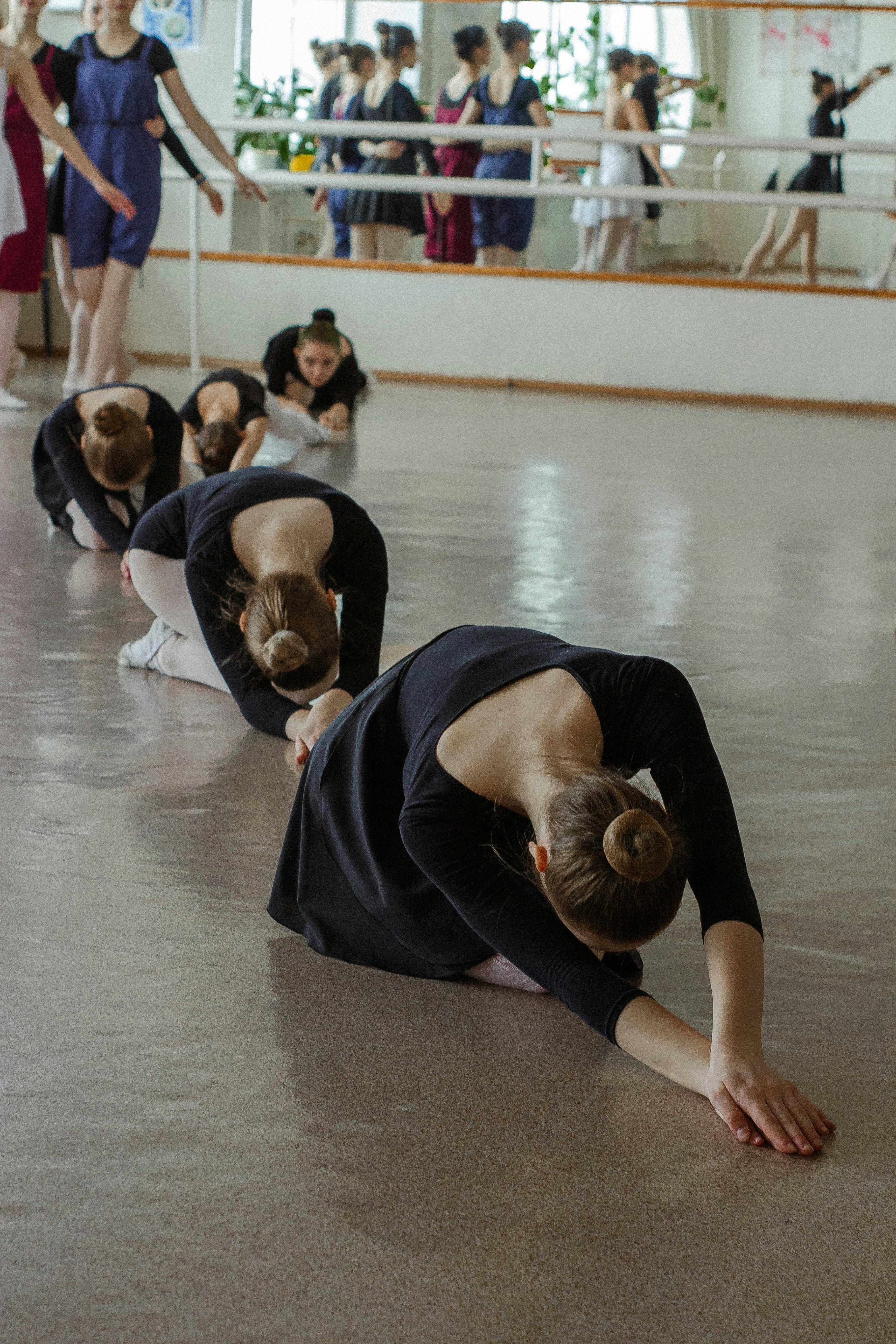 Ballerinas Stretching in Ballet Studio
