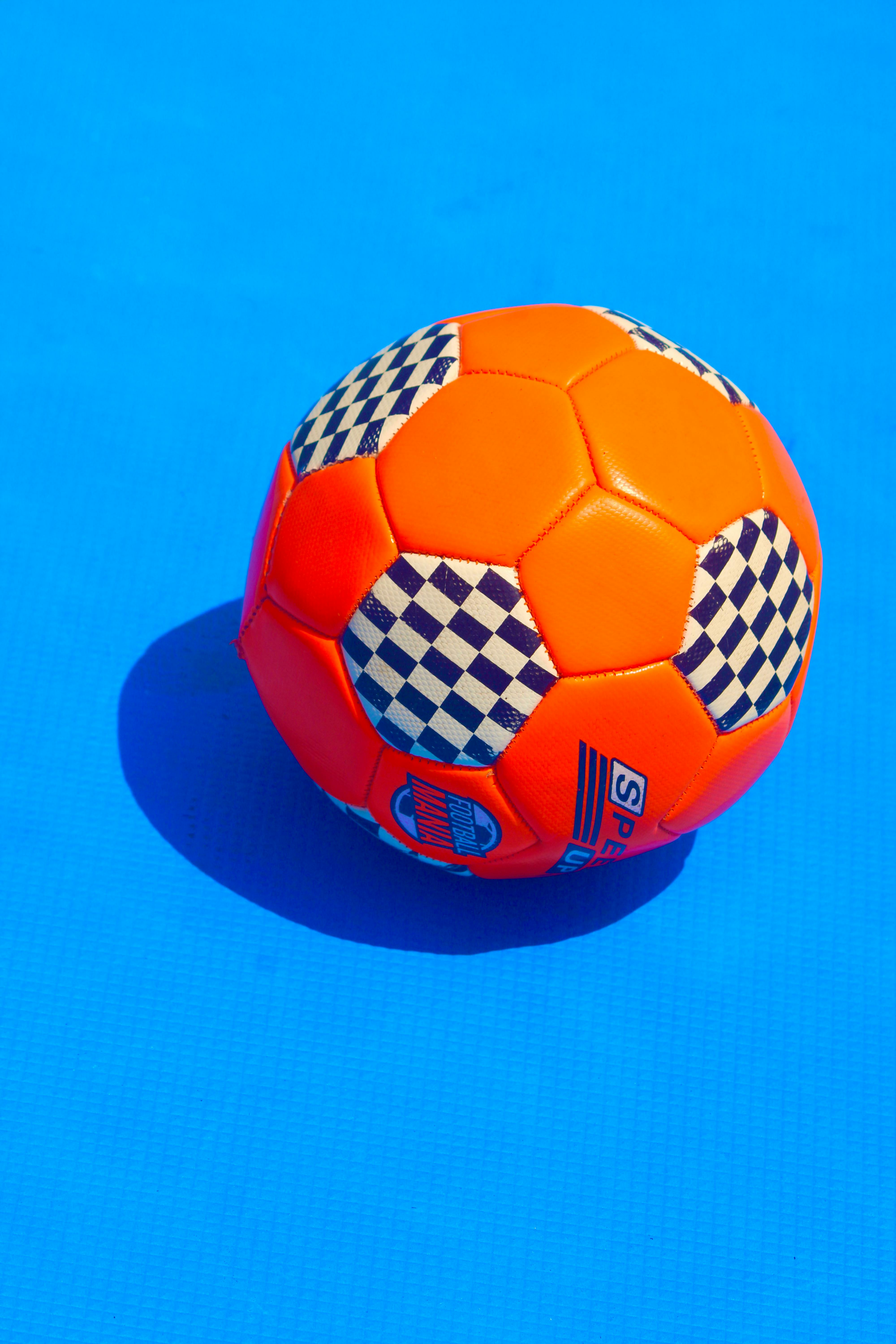 Orange Soccer Ball on Blue Background