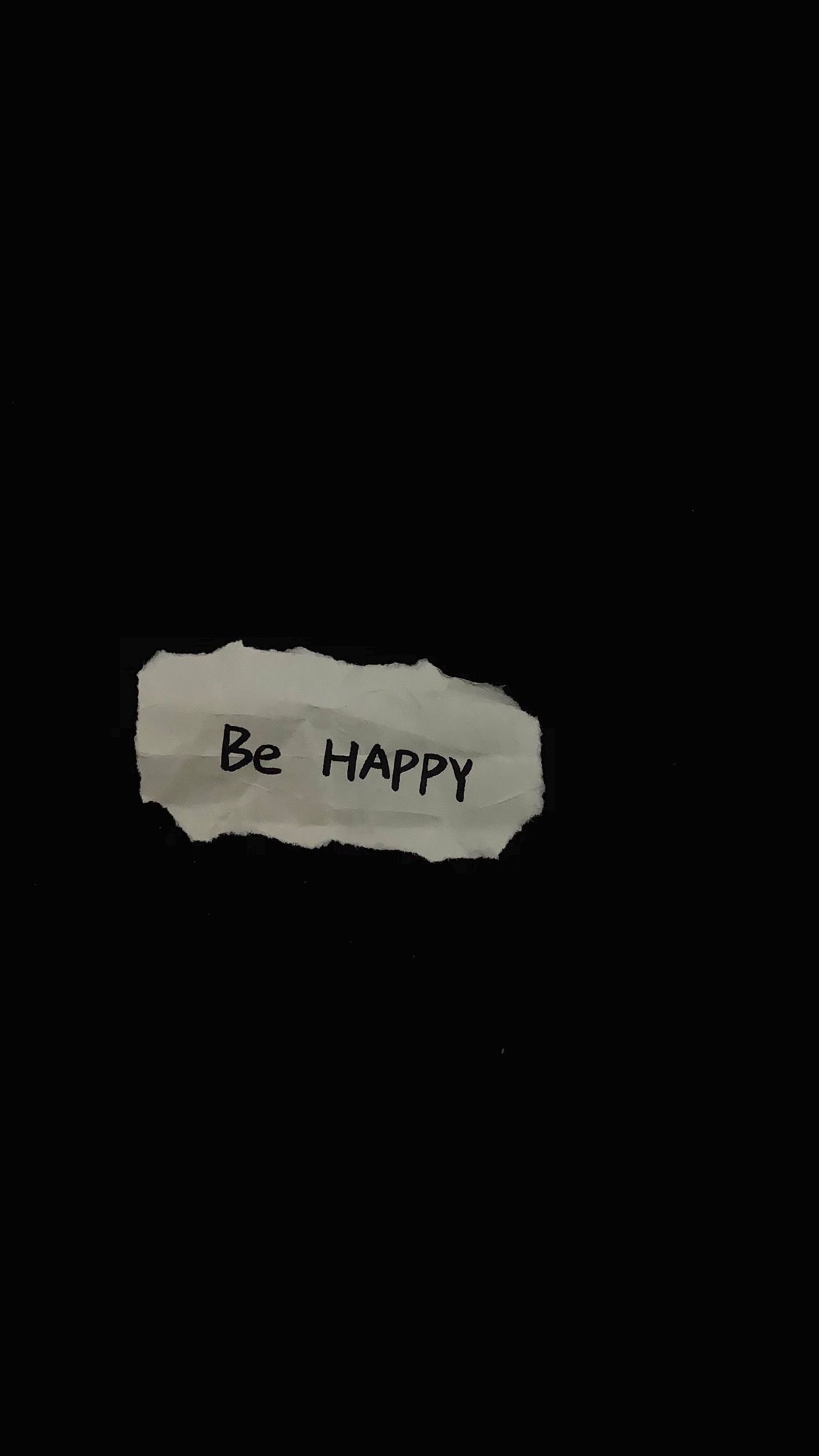 Be Happy Text on Torn Paper