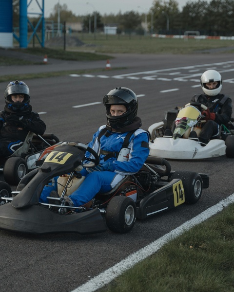 Three Go-Kart Drivers on Outdoor Race Track