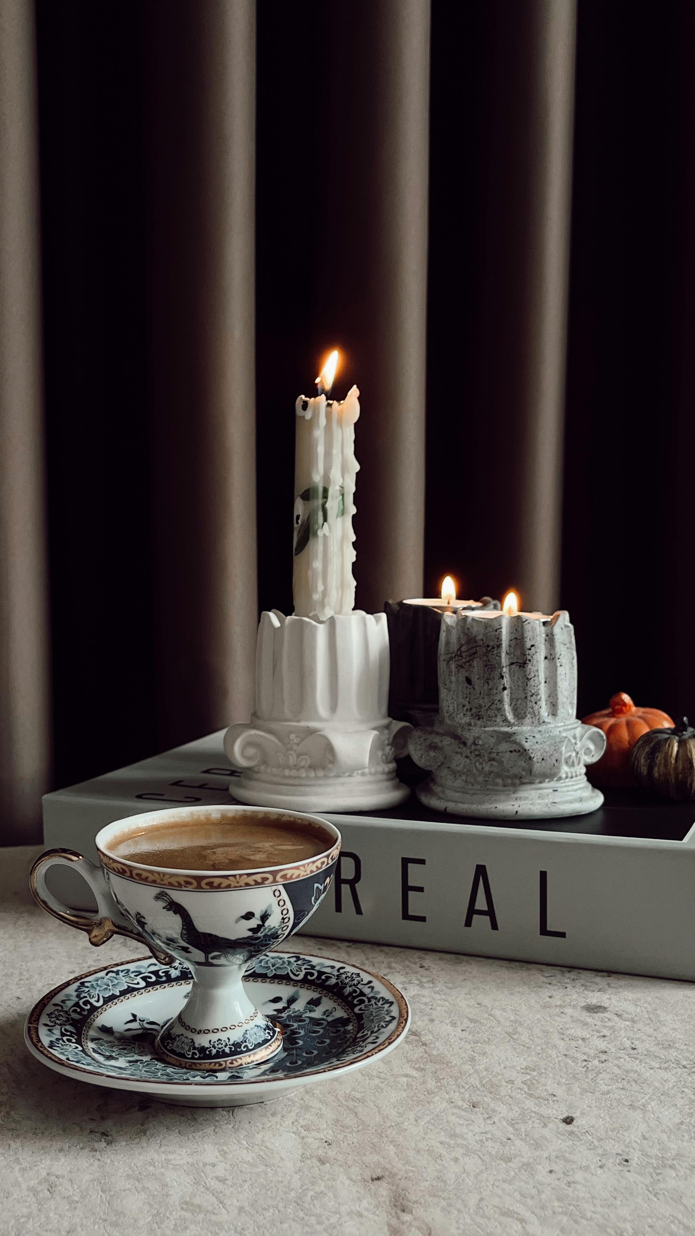 Coffee Cup and Lit Candles Still Life