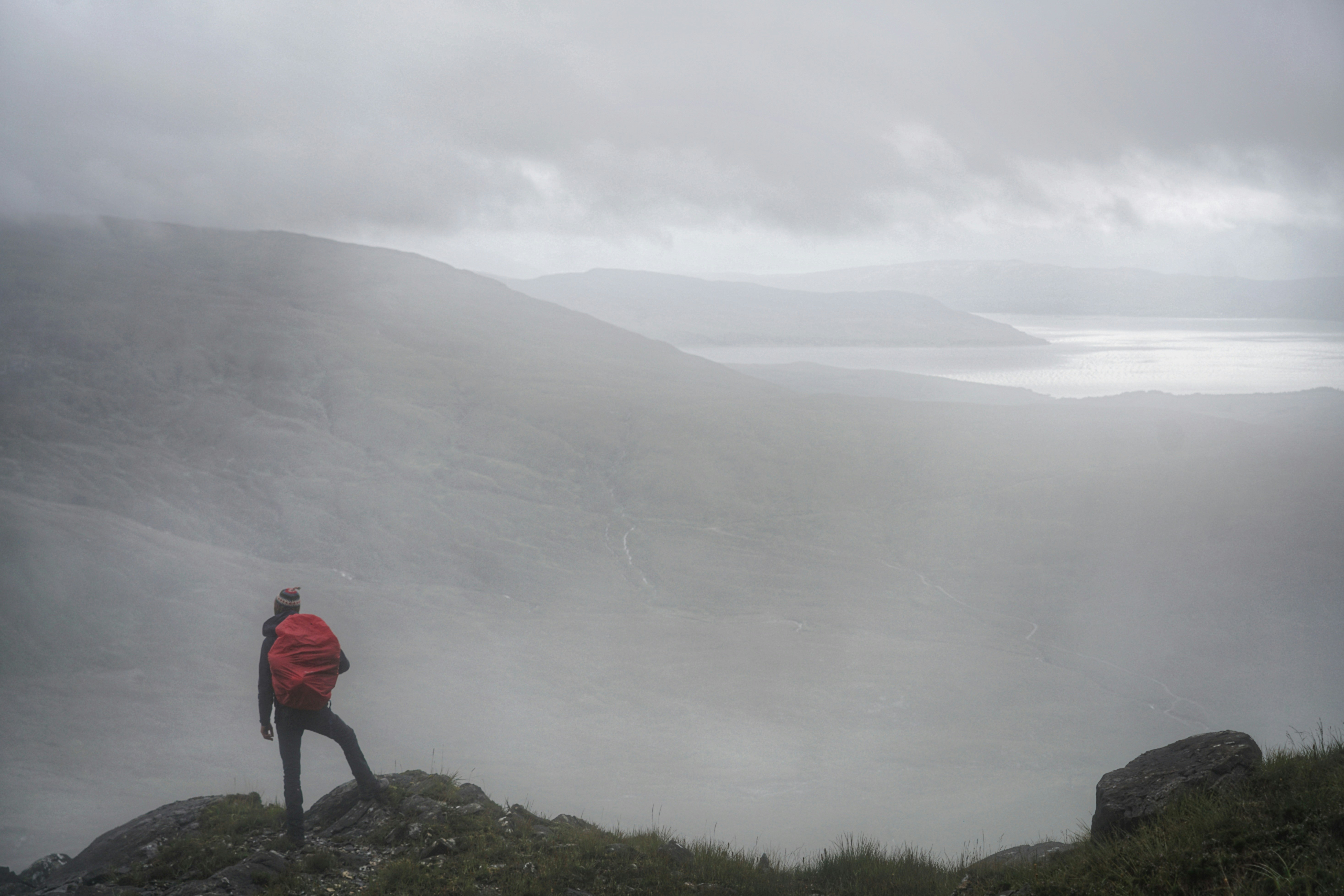 Hiker Overlooks Foggy Mountain Valley