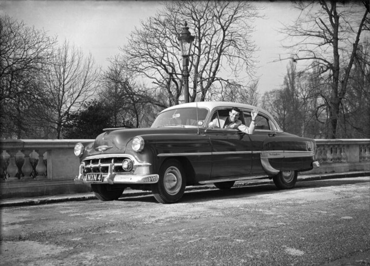 Waving Man in Vintage Sedan — Cars