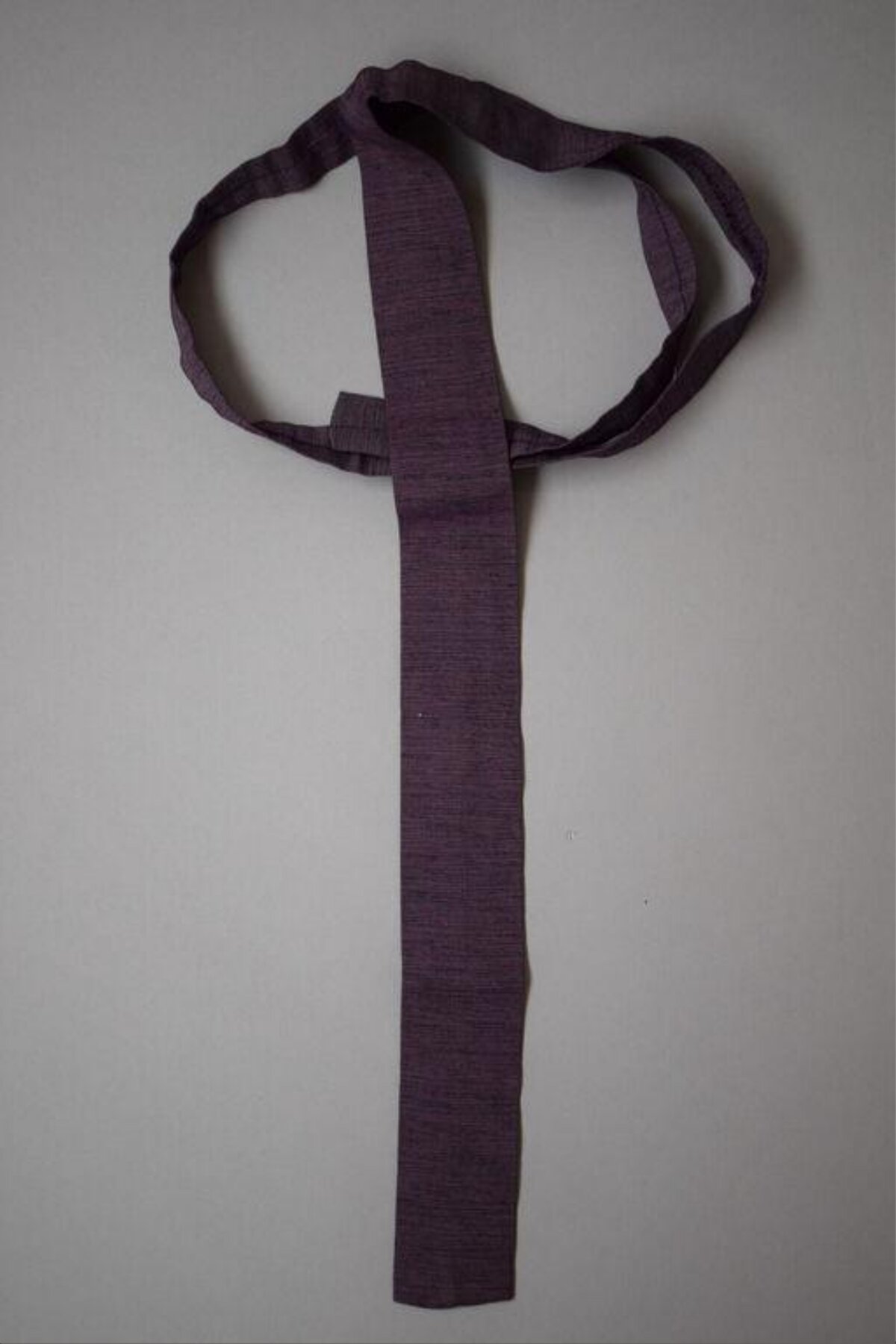 Purple Woven Necktie On Gray Background