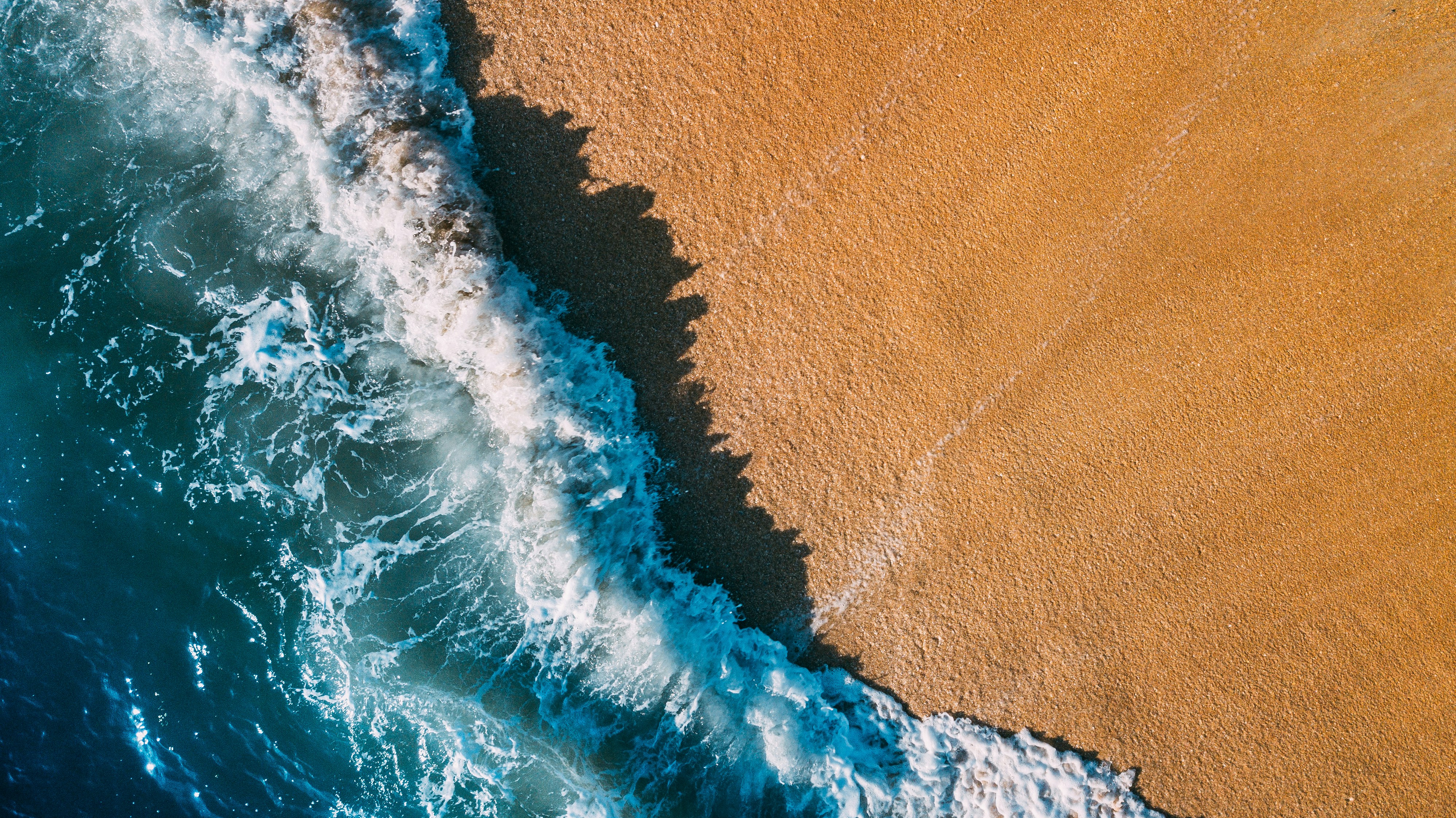 Aerial View of Wave on Beach