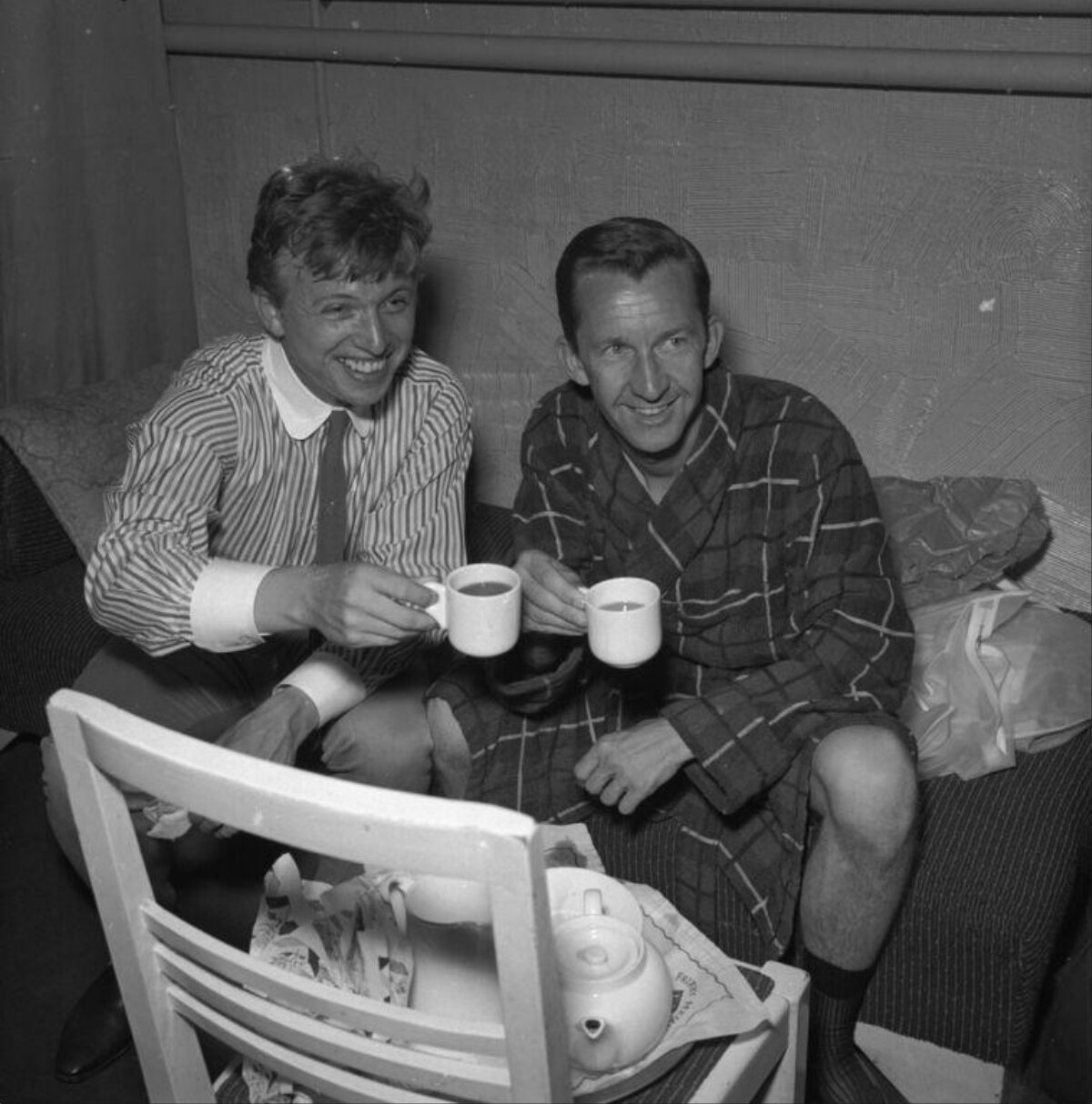Two Men Toasting With Tea Mugs