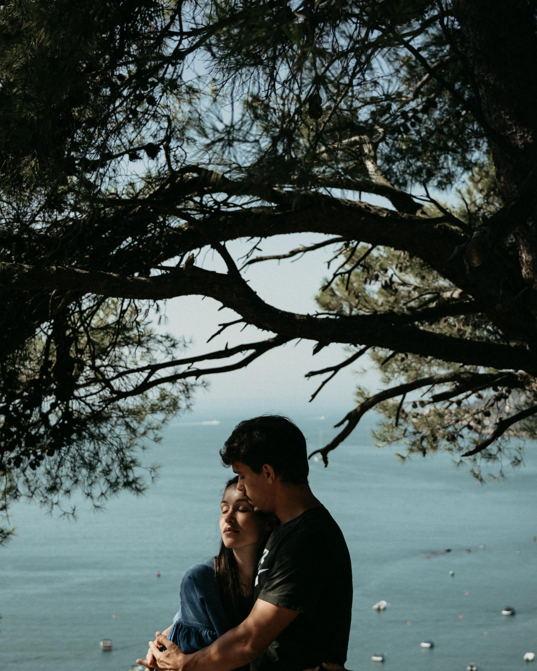 Couple Embracing Overlooking Calm Sea
