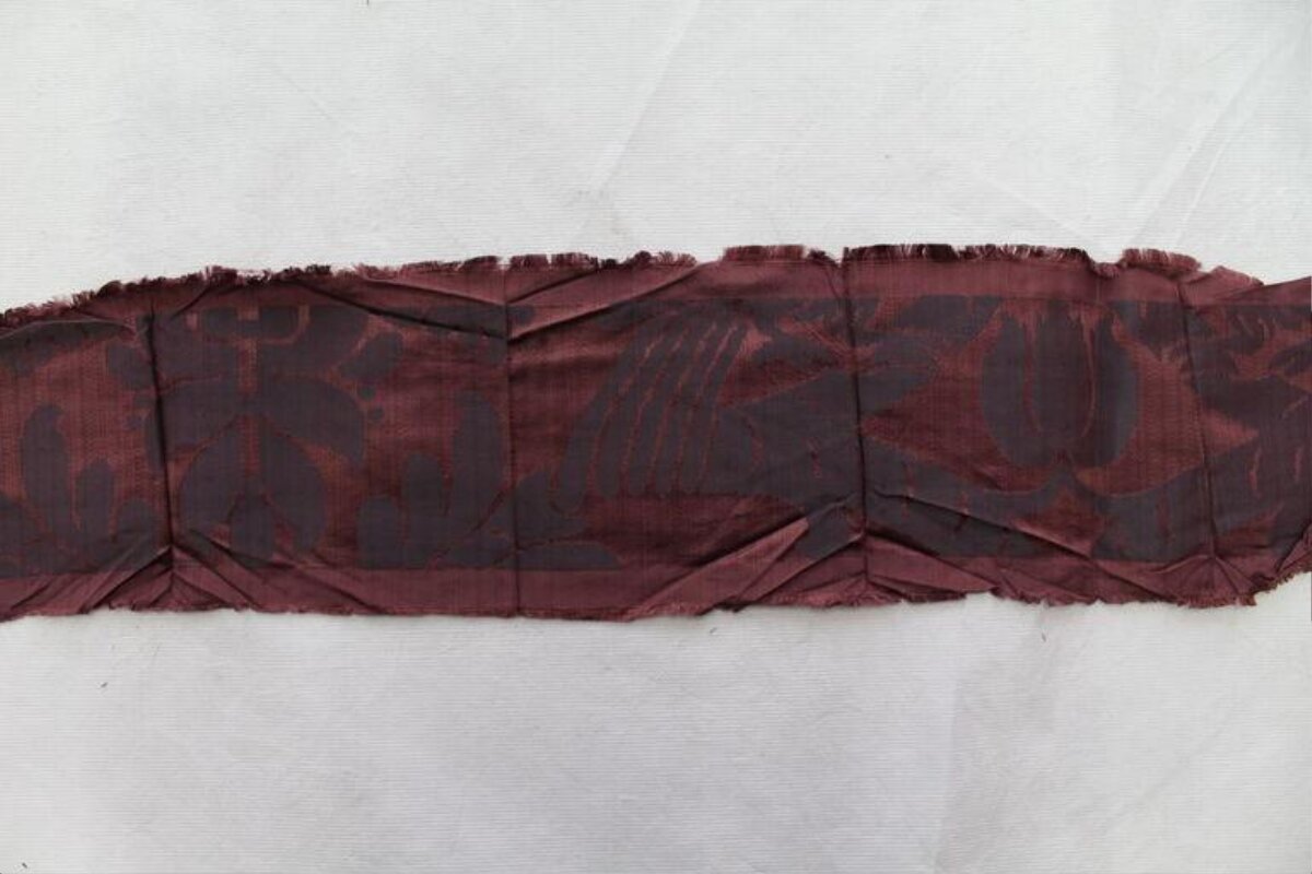 Frayed Maroon Fabric Strip on White Background