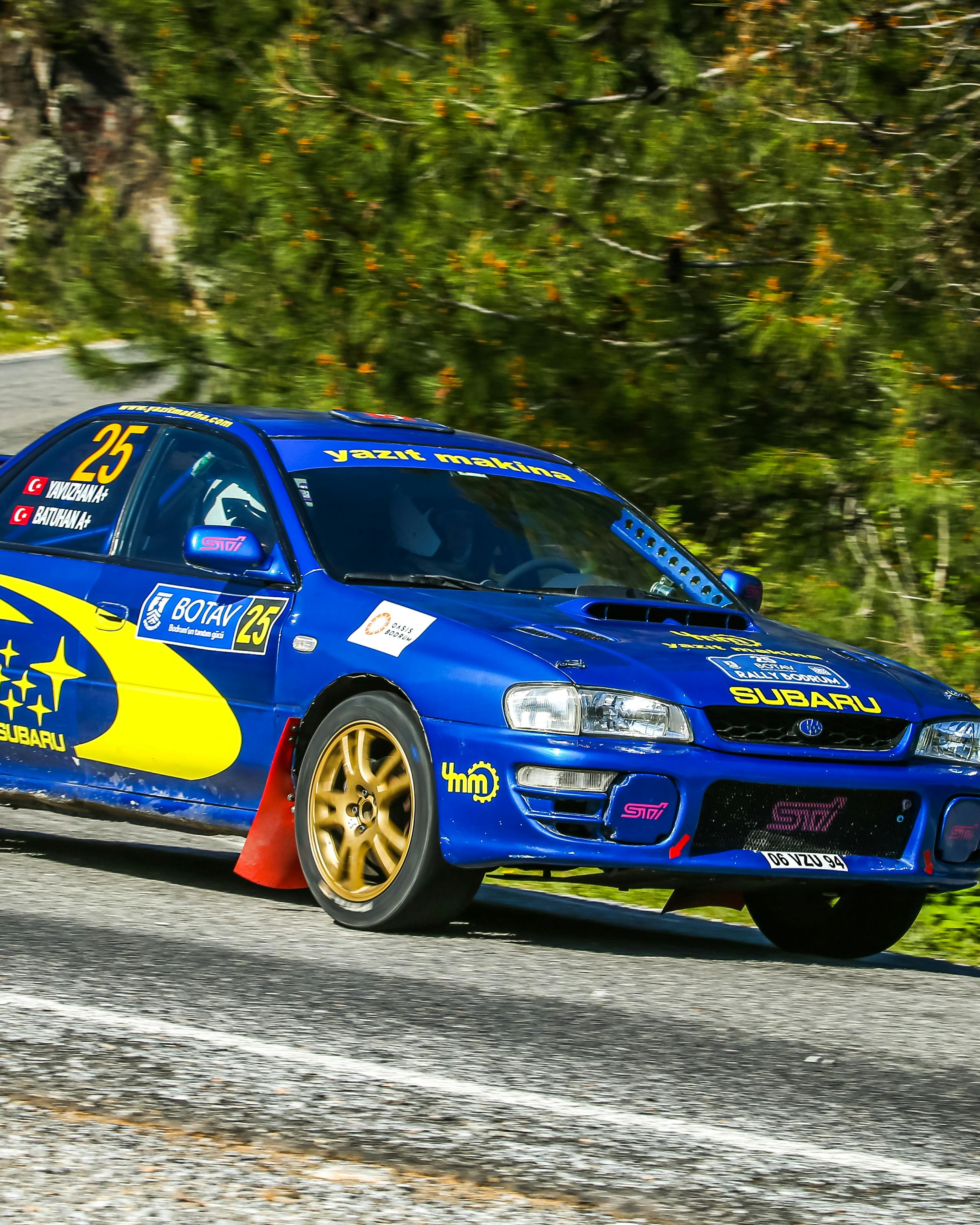 Blue Subaru Rally Car on Mountain Road